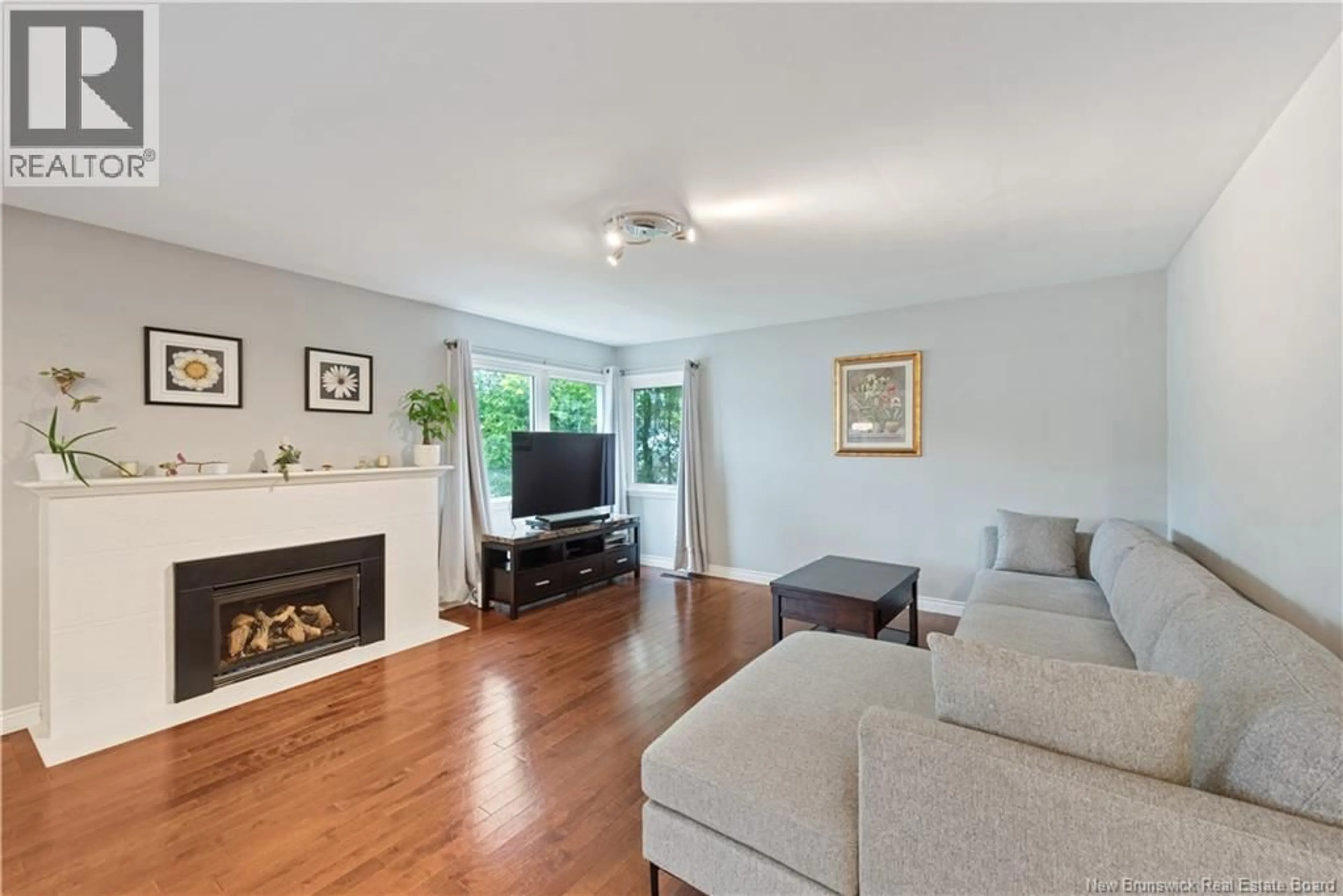Living room with furniture, wood/laminate floor for 21 READE STREET, Moncton New Brunswick E1C6S1