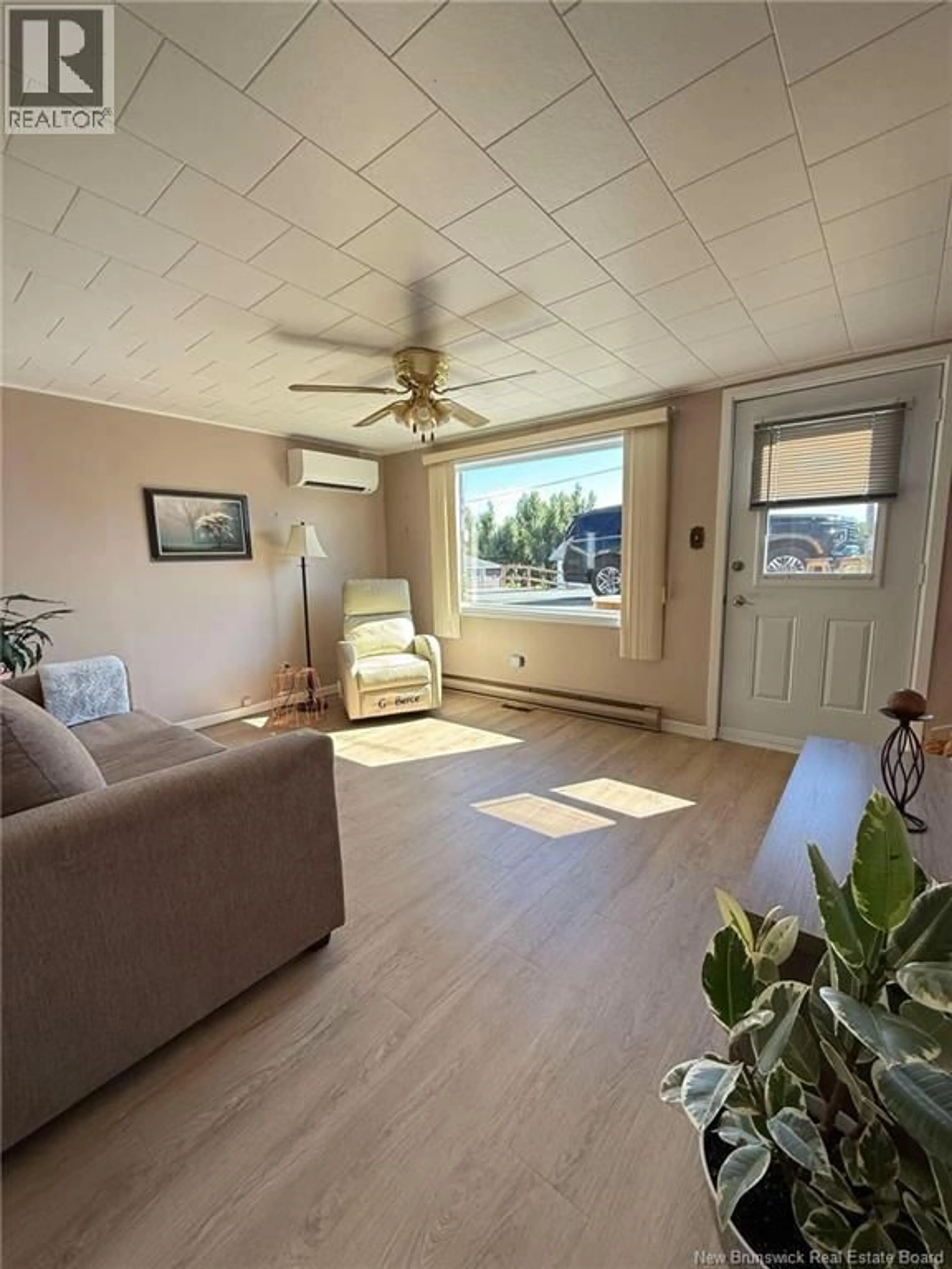 Living room with furniture, wood/laminate floor for 397 SANSOM STREET, Dalhousie New Brunswick E8C2L4