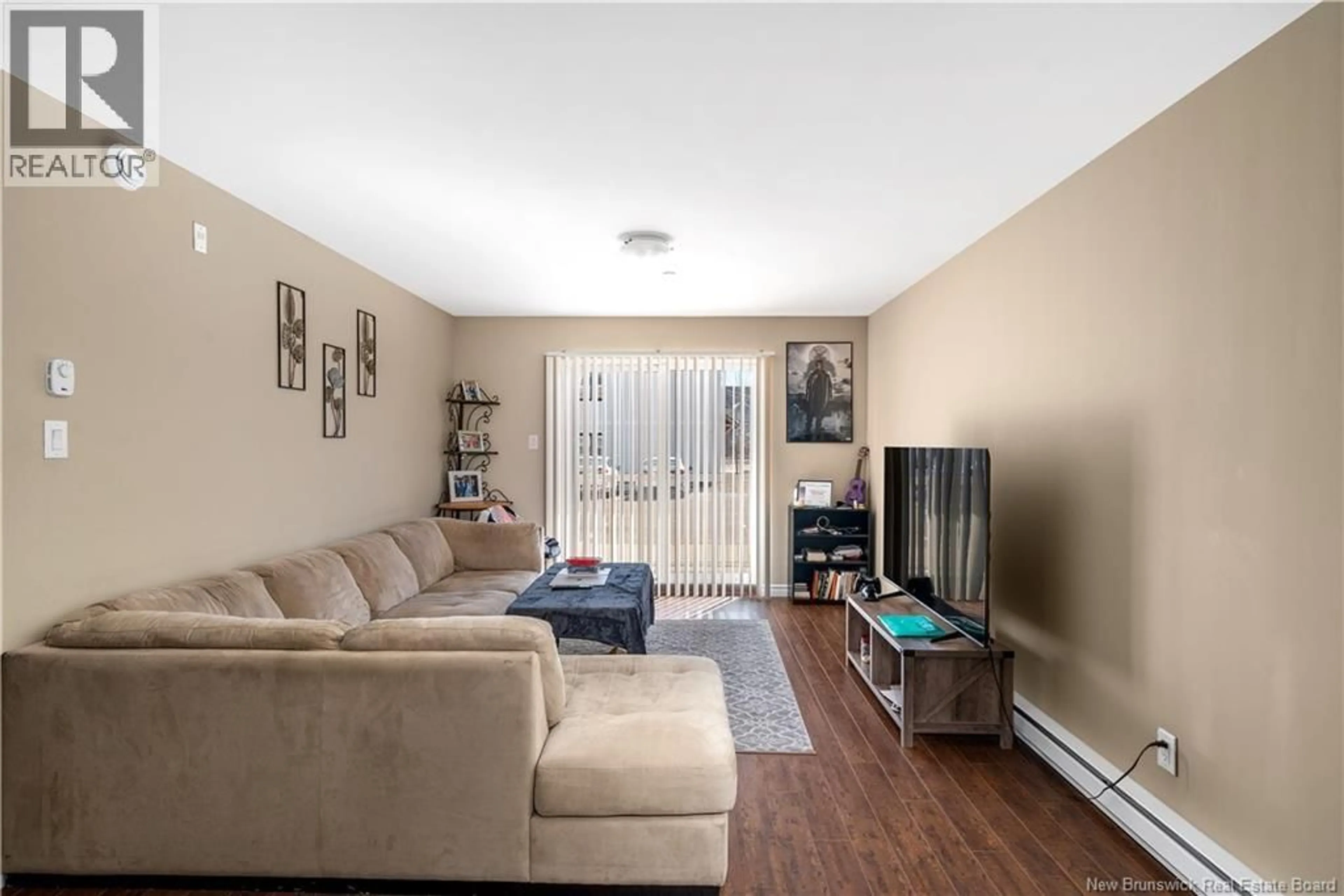 Living room with furniture, wood/laminate floor for 106 - 33 SIFROI STREET, Dieppe New Brunswick E1A5T1