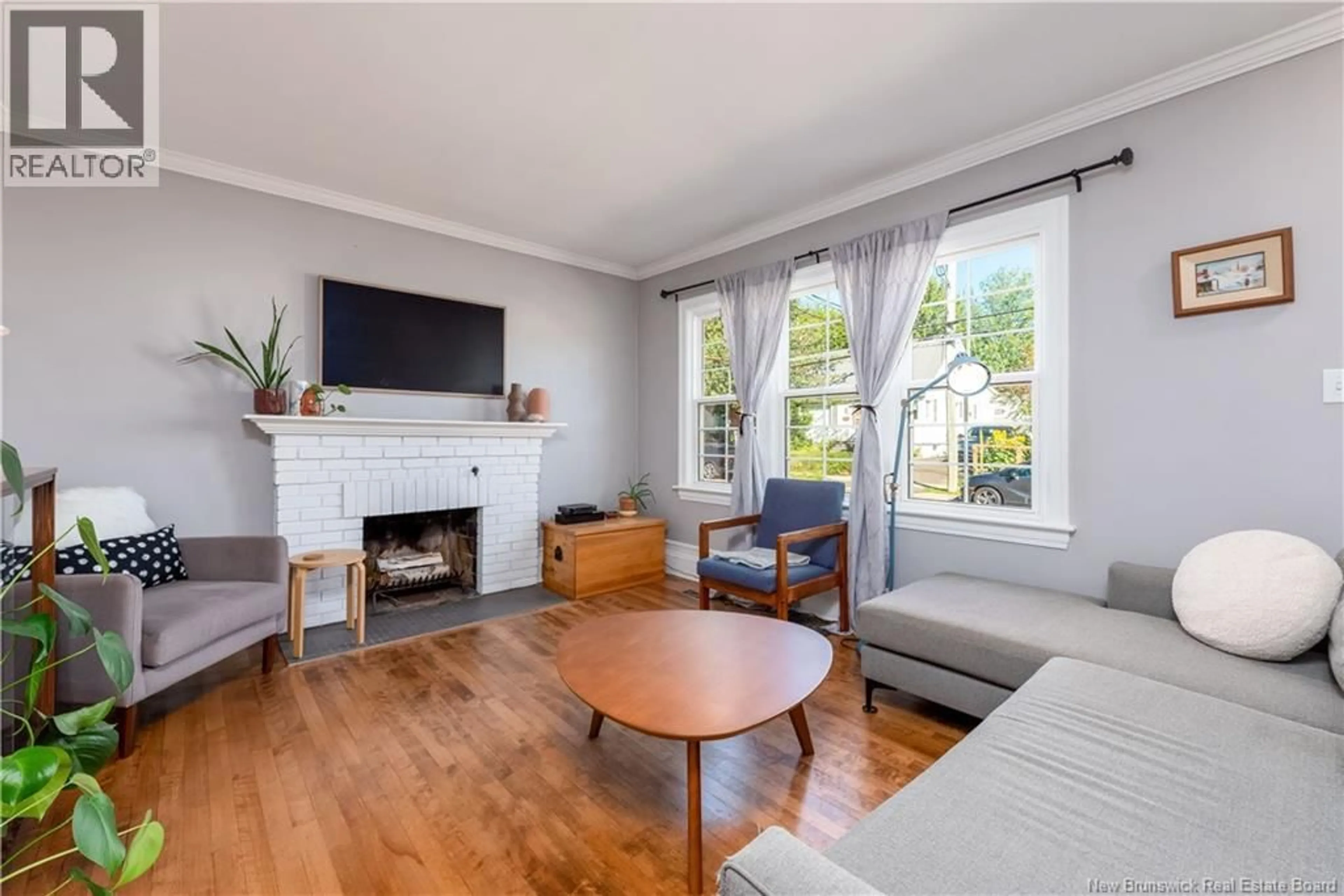 Living room with furniture, wood/laminate floor for 48 SHERRARD AVENUE, Moncton New Brunswick E1C3J6