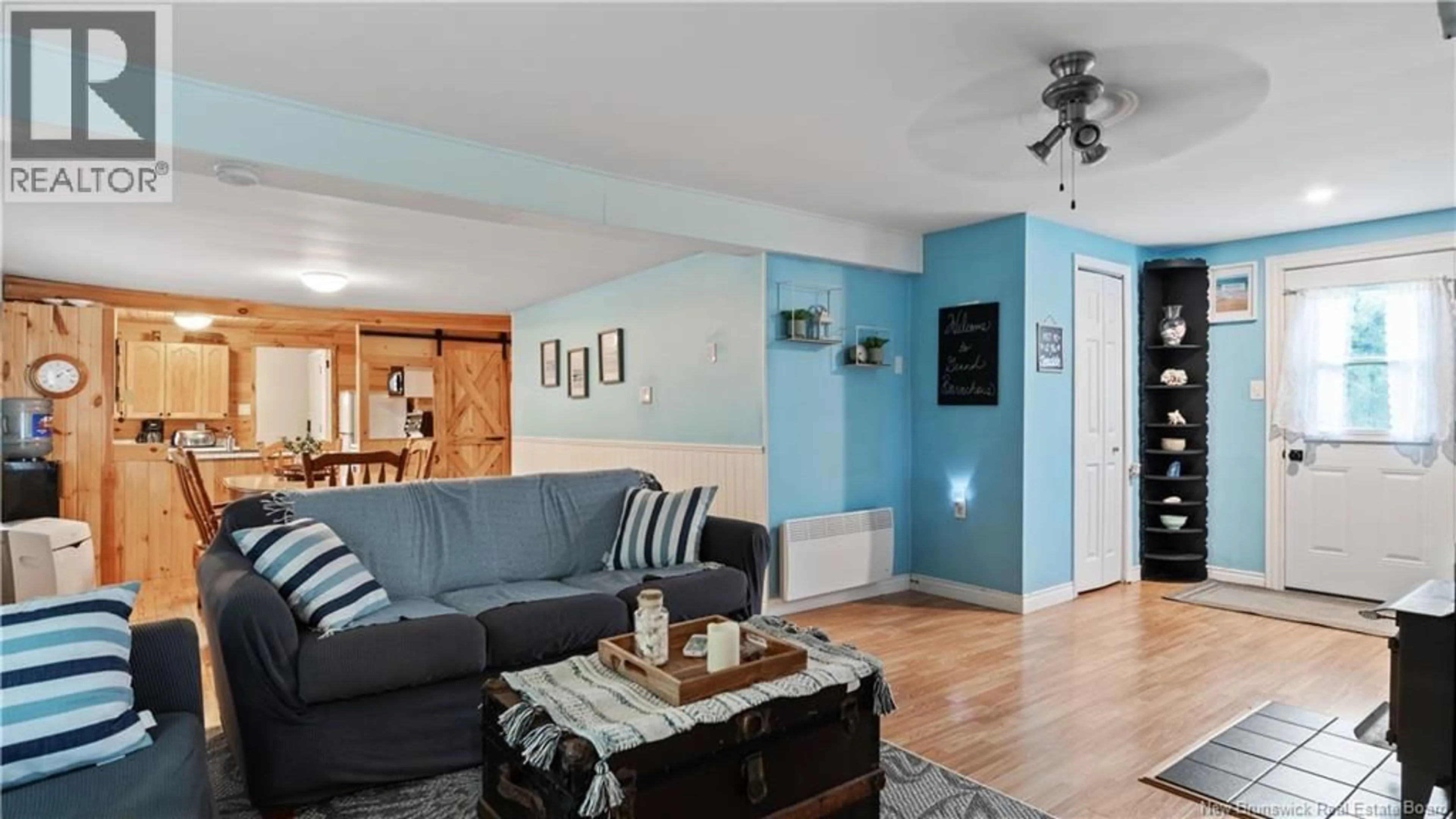 Living room with furniture, wood/laminate floor for 6 STE MARIE STREET, Grand-Barachois New Brunswick E4P8N5