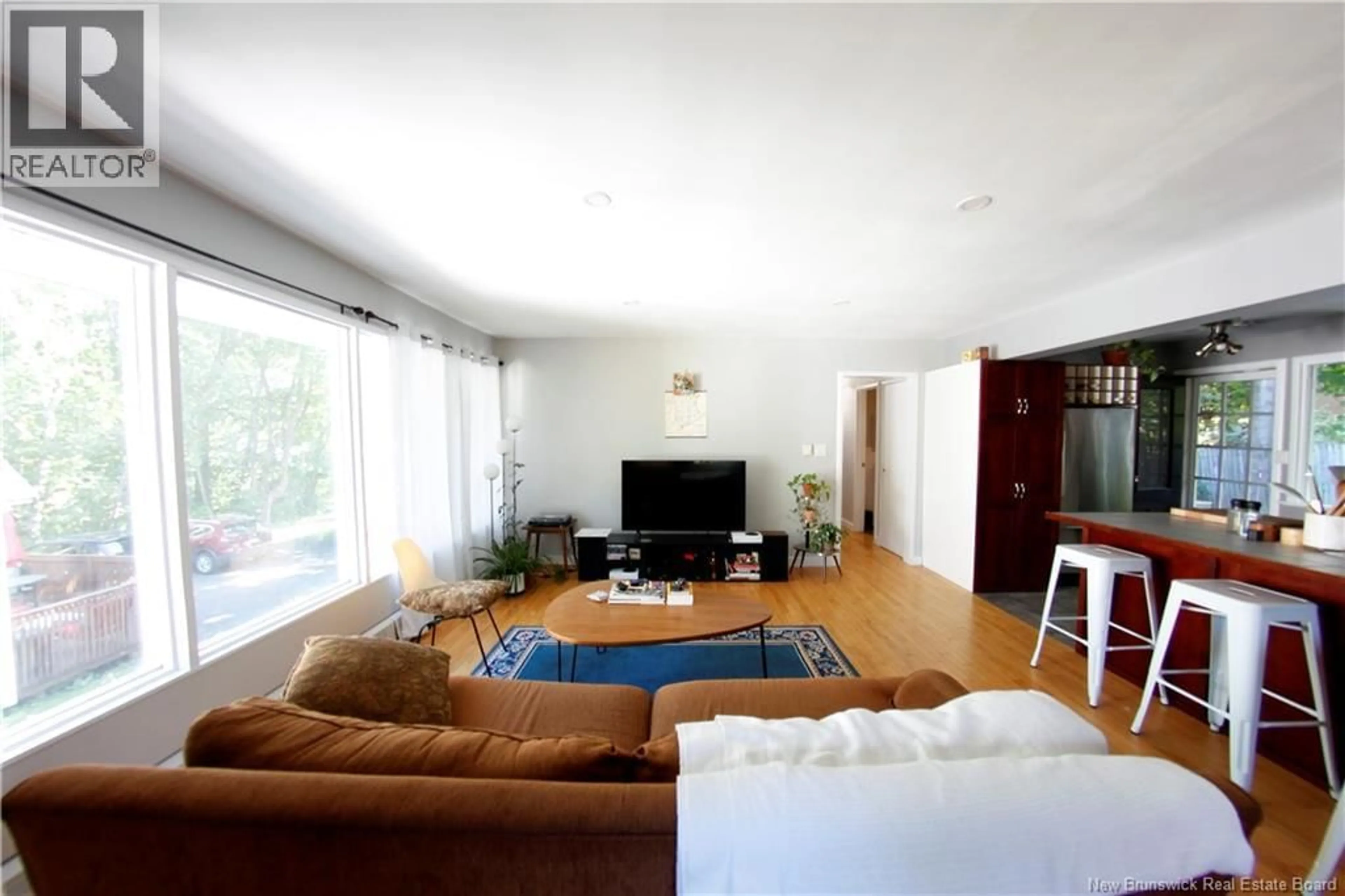 Living room with furniture, wood/laminate floor for 628-630 - 630 YORK STREET, Fredericton New Brunswick E3B3R5