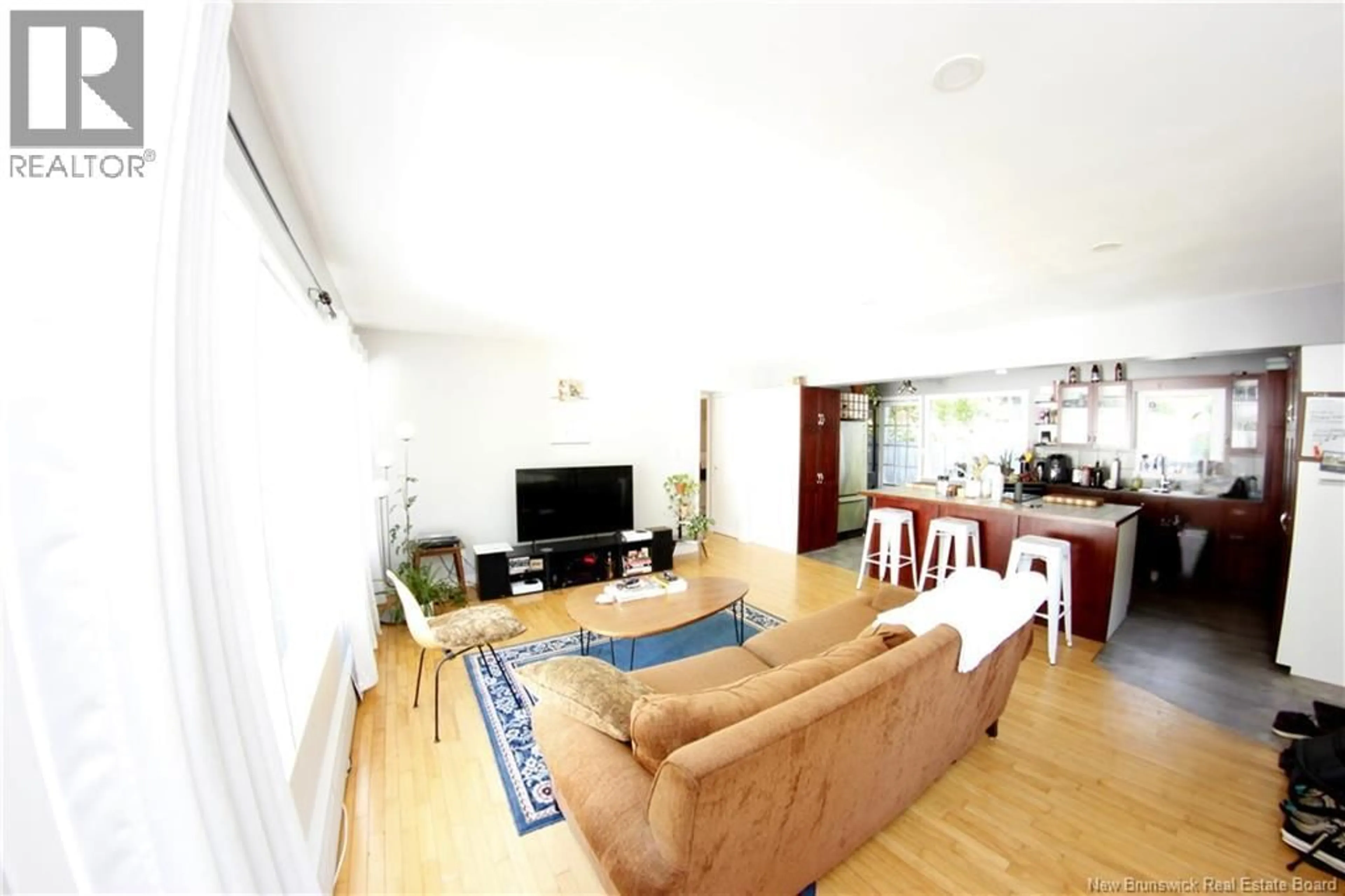 Living room with furniture, wood/laminate floor for 628-630 - 630 YORK STREET, Fredericton New Brunswick E3B3R5