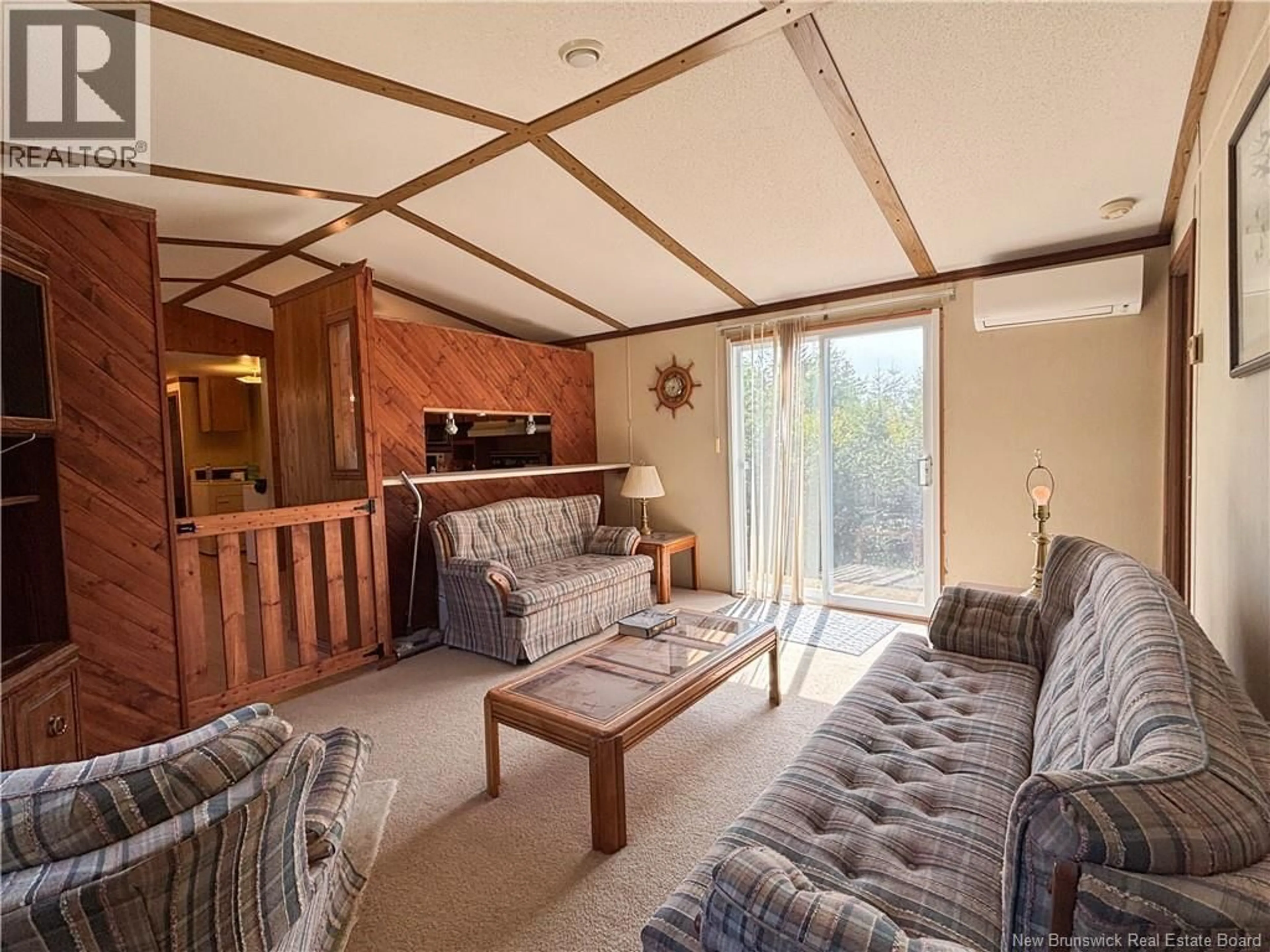 Living room with furniture, wood/laminate floor for 57 MILLERS POND ROAD, Grand Manan New Brunswick E5G2G9