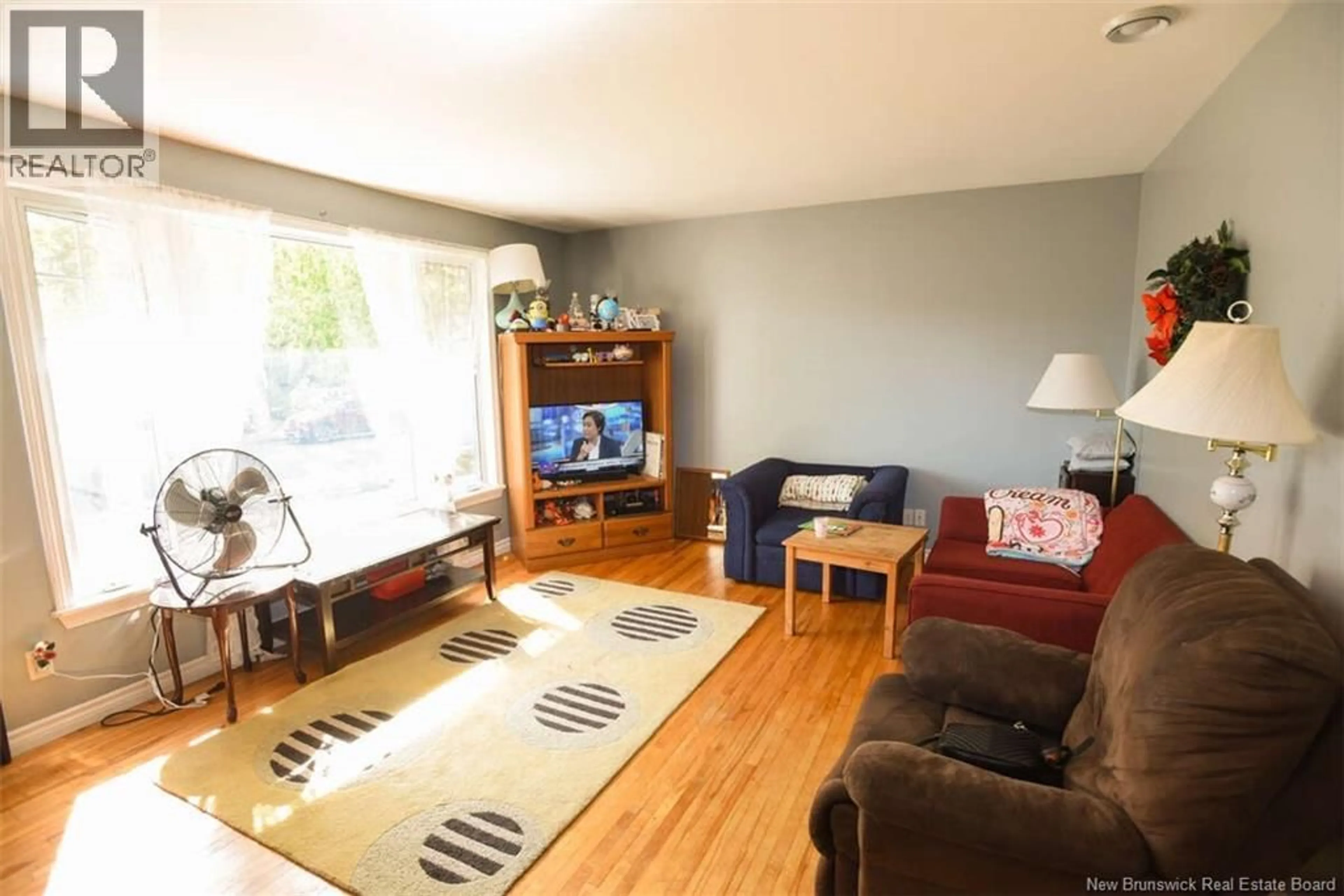 Living room with furniture, wood/laminate floor for 227 LEEDS DRIVE, Fredericton New Brunswick E3B4S7