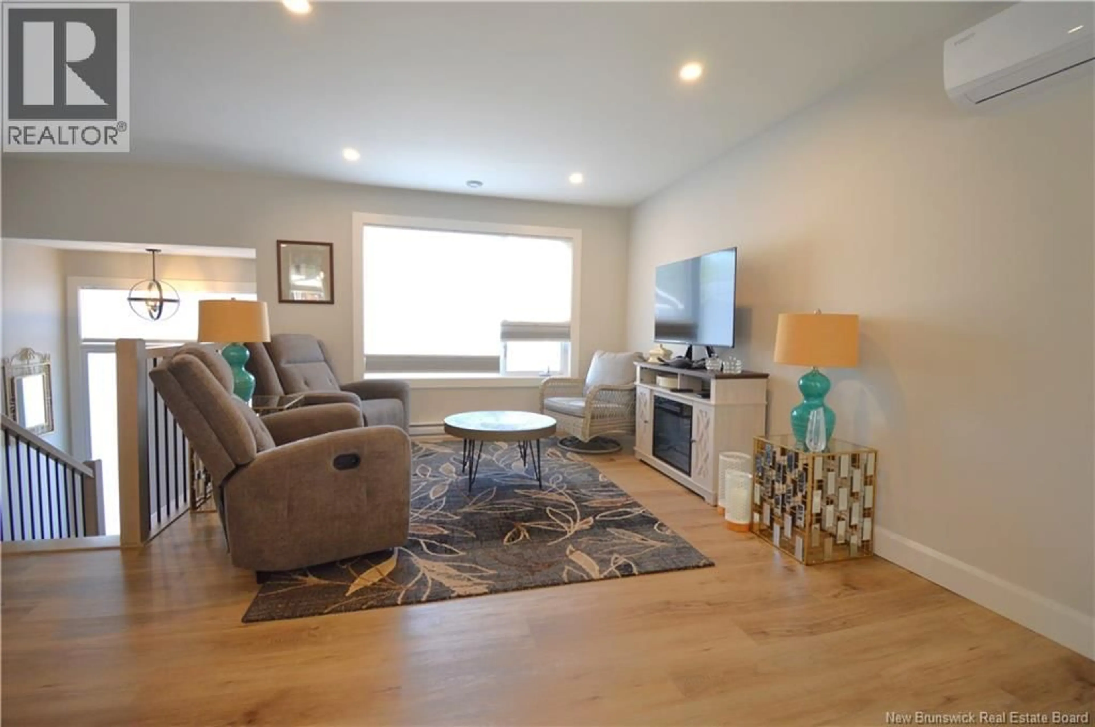 Living room with furniture, wood/laminate floor for 303 CHATELLERAULT, Shediac New Brunswick E4P0L3