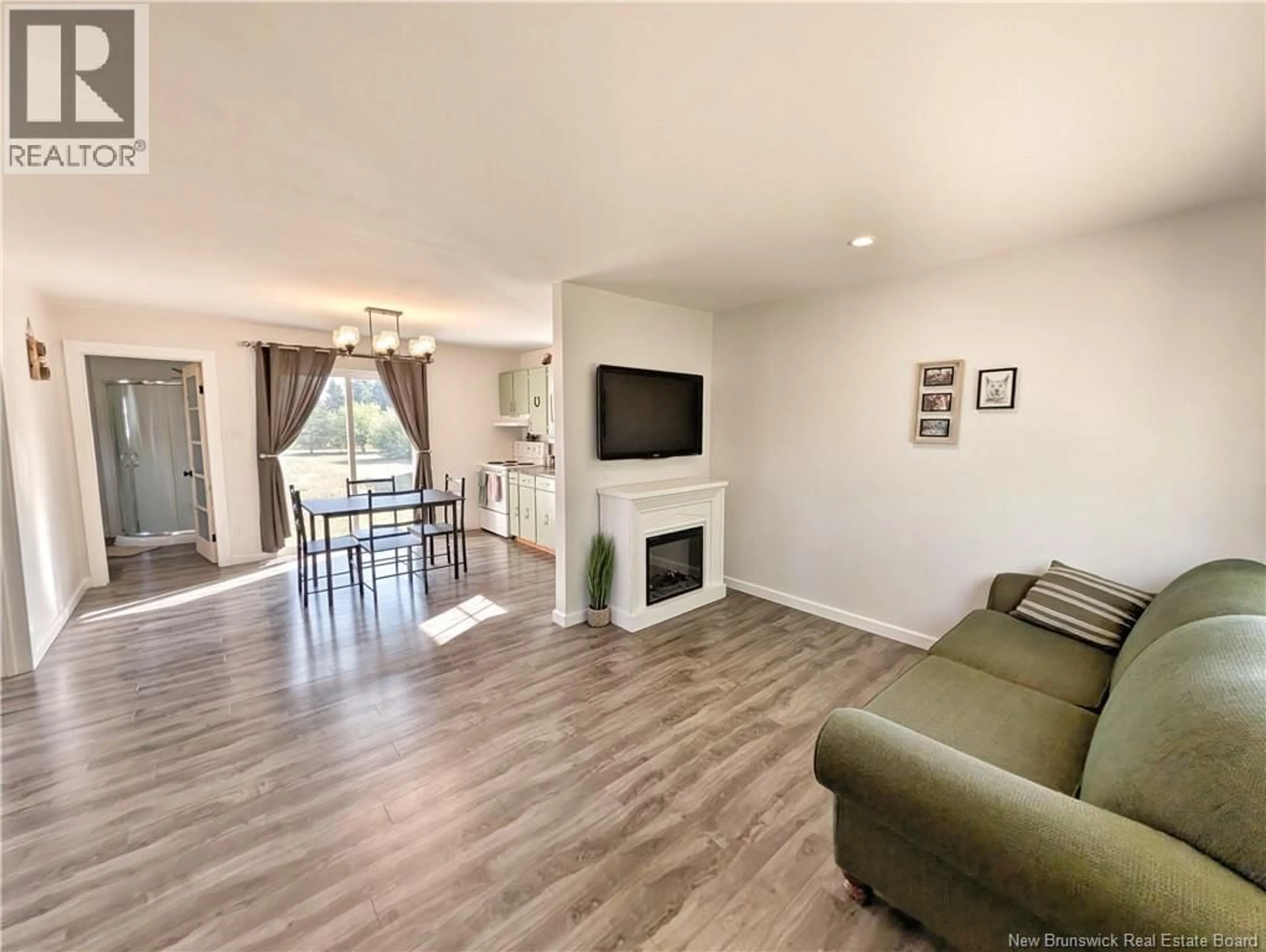 Living room with furniture, wood/laminate floor for 749 SAINT-JOSEPH BOULEVARD, Saint-Léolin New Brunswick E8N2N3