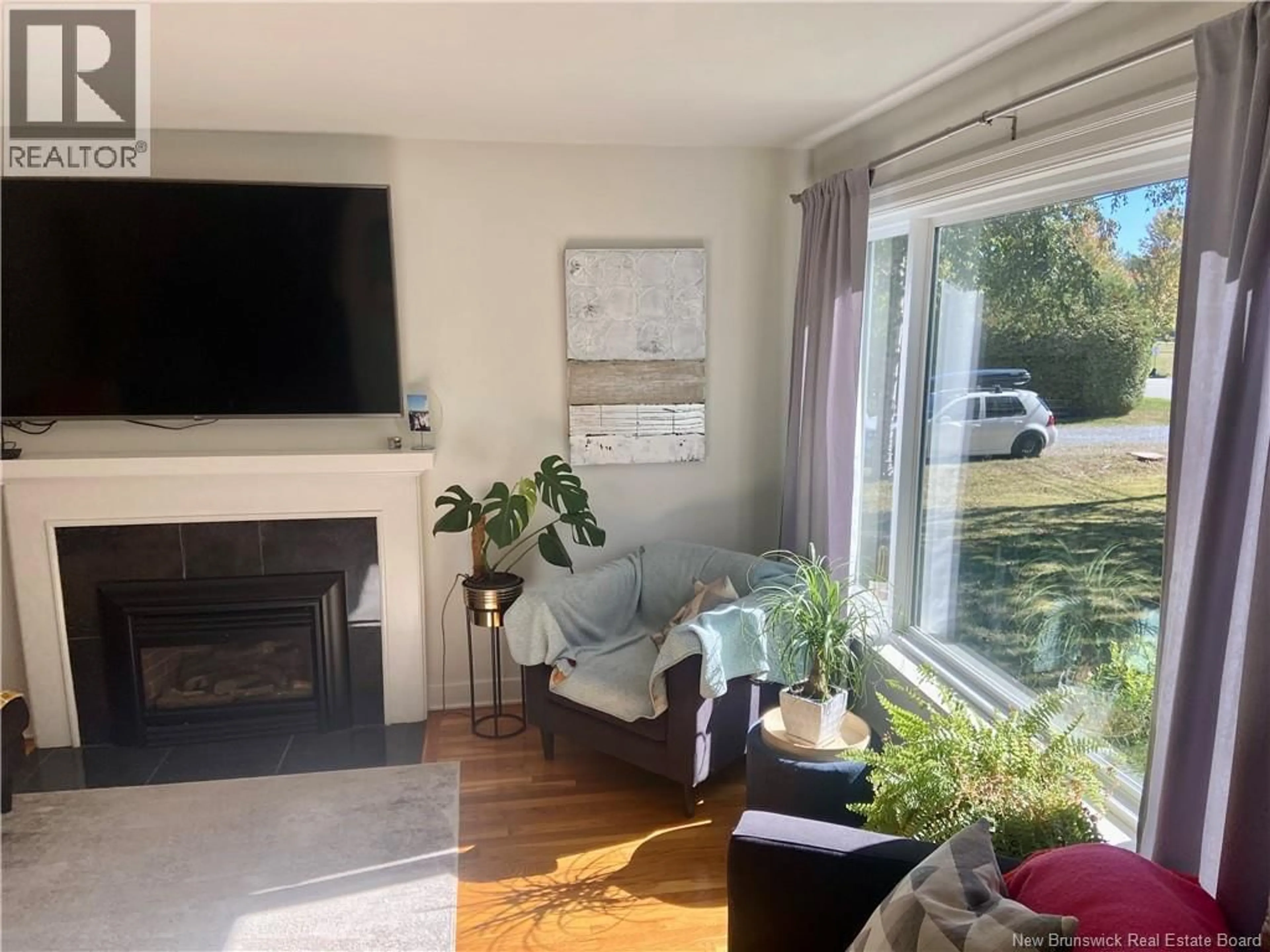 Living room with furniture, wood/laminate floor for 21 BROADWAY STREET, Rothesay New Brunswick E2H1B3