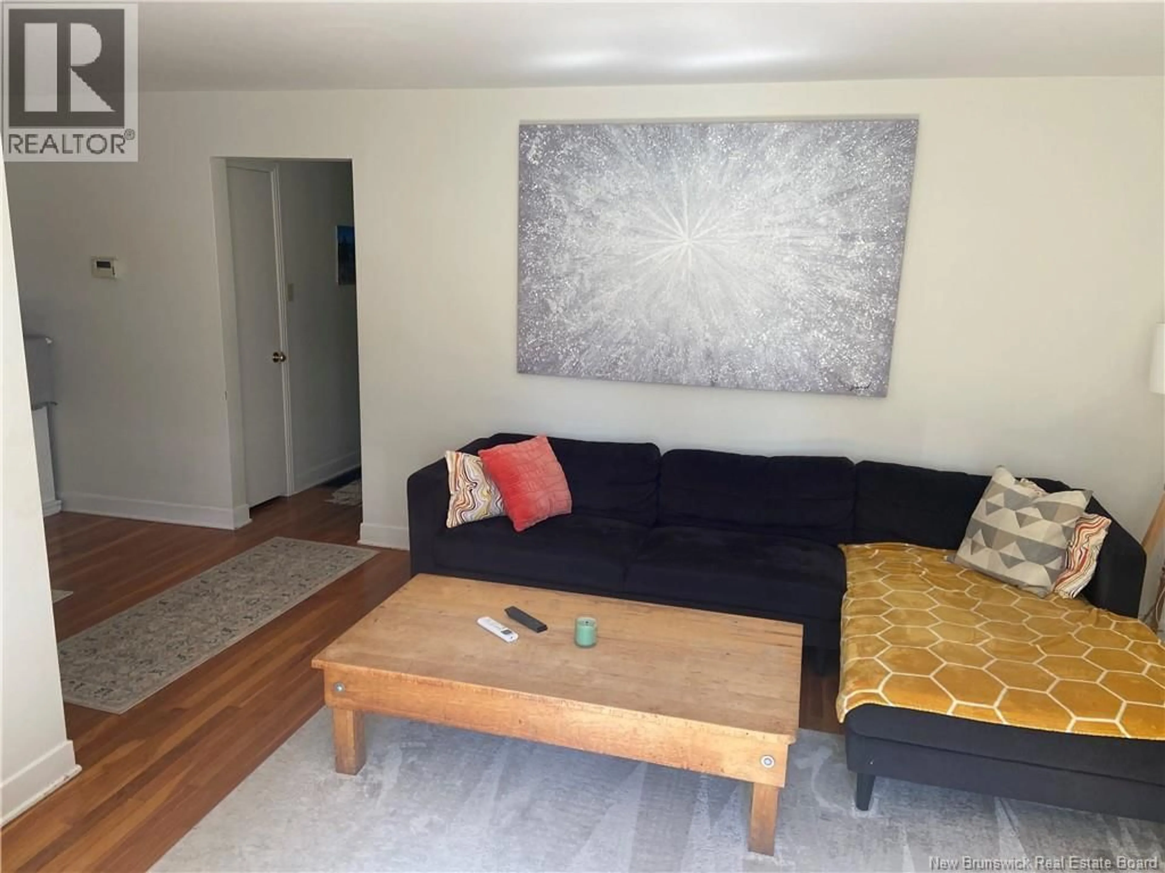 Living room with furniture, wood/laminate floor for 21 BROADWAY STREET, Rothesay New Brunswick E2H1B3
