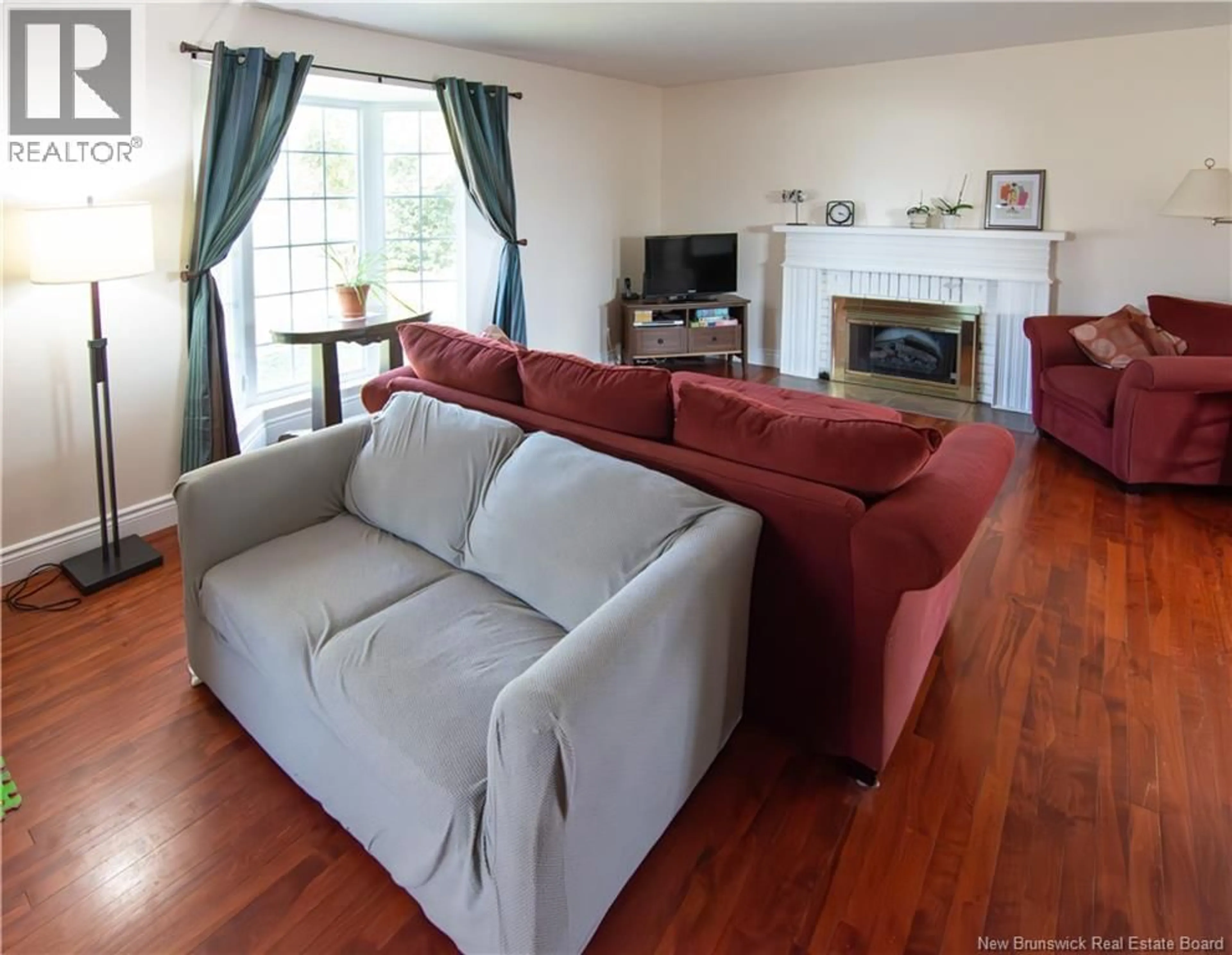 Living room with furniture, wood/laminate floor for 58 GLENWOOD DRIVE, Moncton New Brunswick E1A2M9
