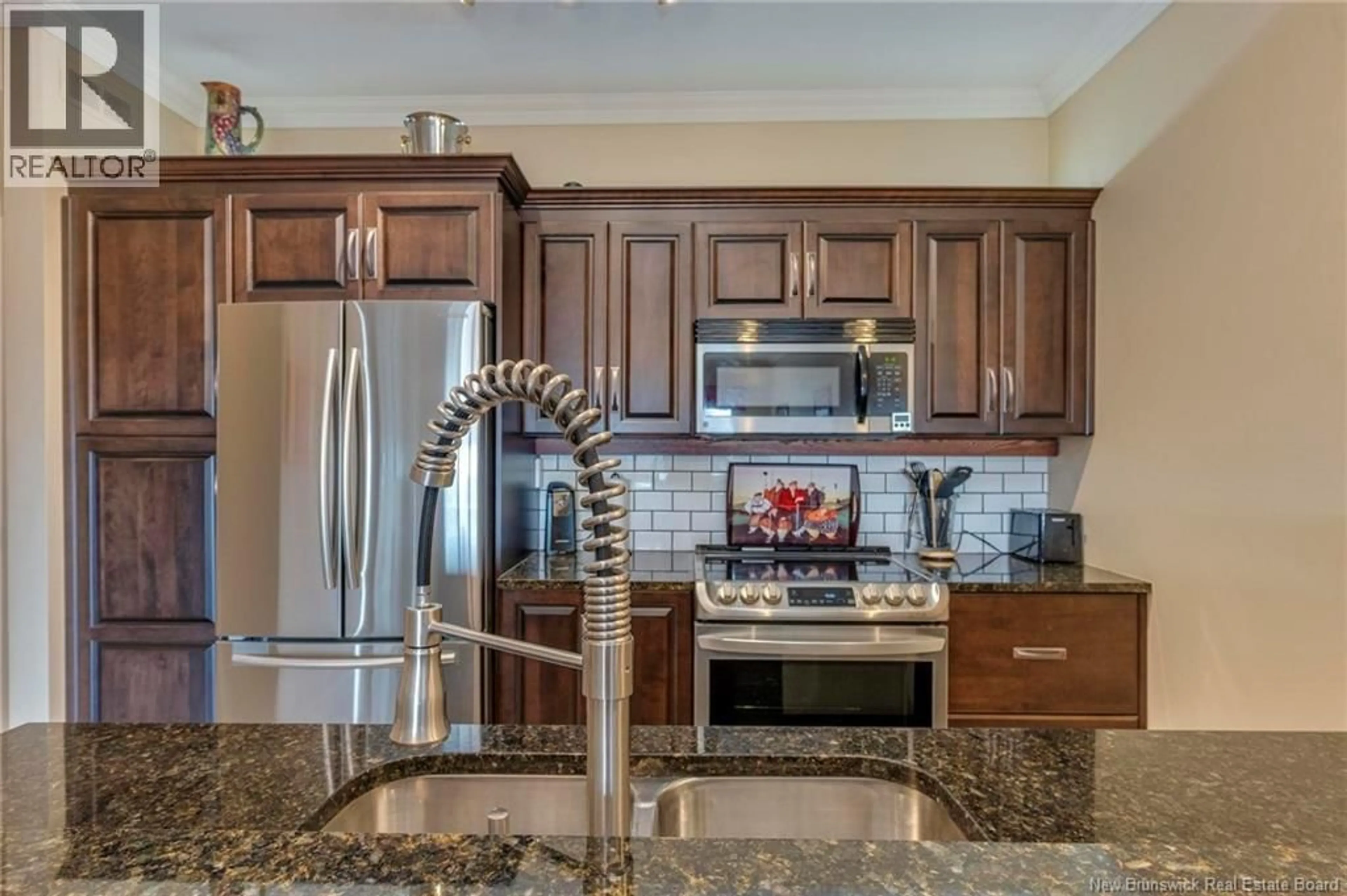 Open concept kitchen, ceramic/tile floor for 207 - 88 WOODS TERRACE, Moncton New Brunswick E1G1X6