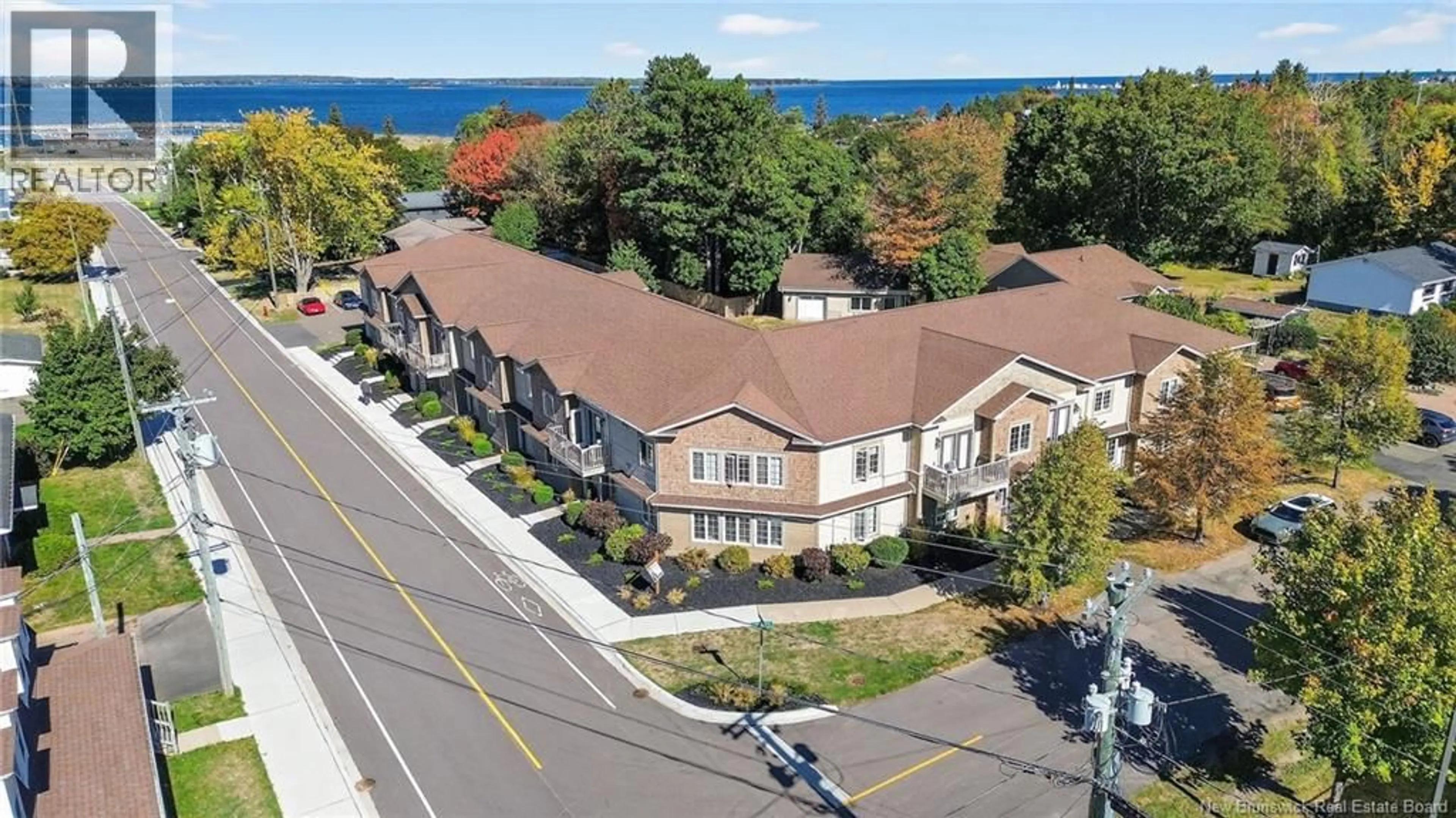 A pic from outside/outdoor area/front of a property/back of a property/a pic from drone, water/lake/river/ocean view for 201 - 98 PLEASANT STREET, Shediac New Brunswick E4P2L6