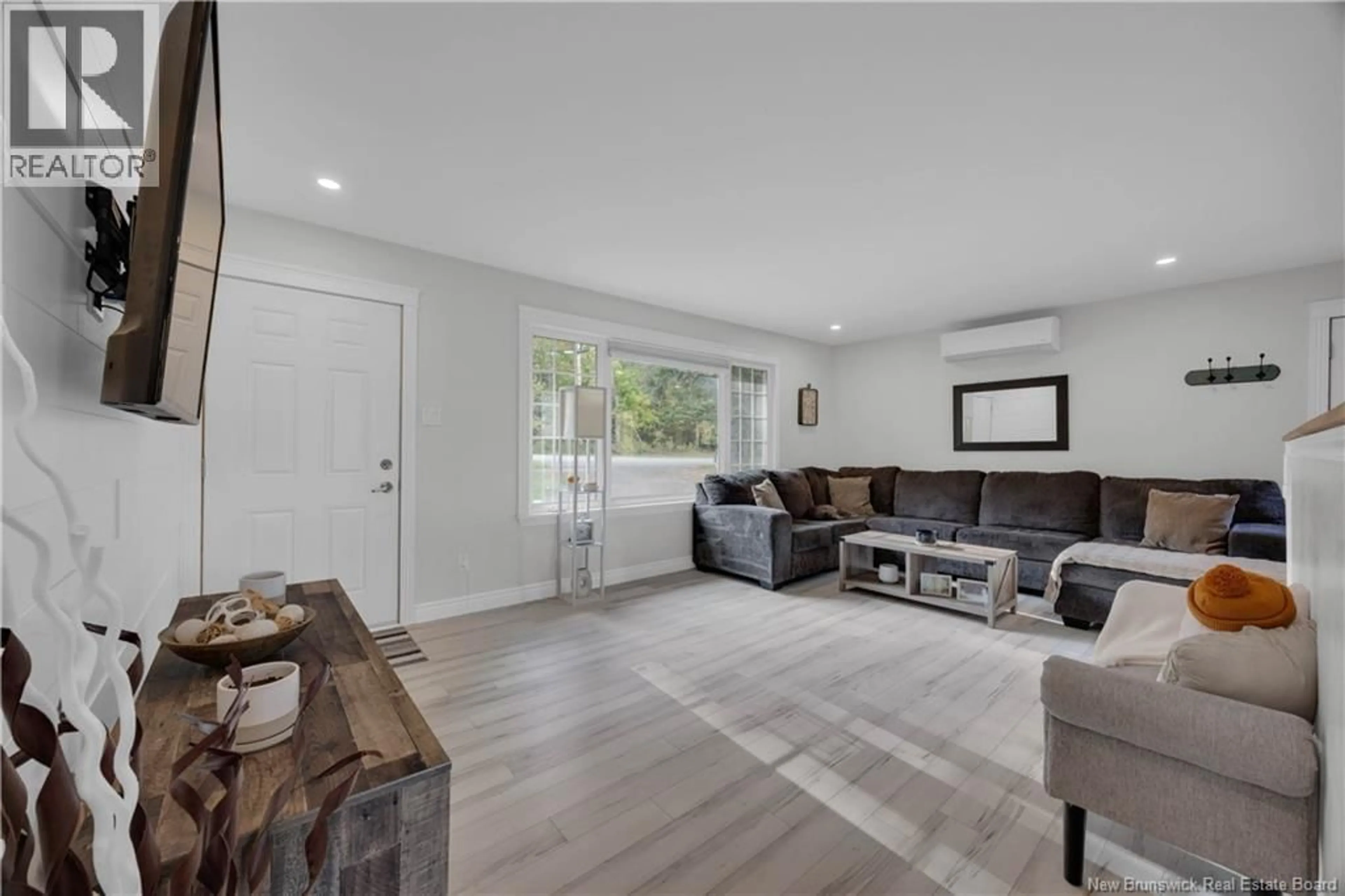 Living room with furniture, wood/laminate floor for 1 WOODRIDGE DRIVE, Quispamsis New Brunswick E2G1A2