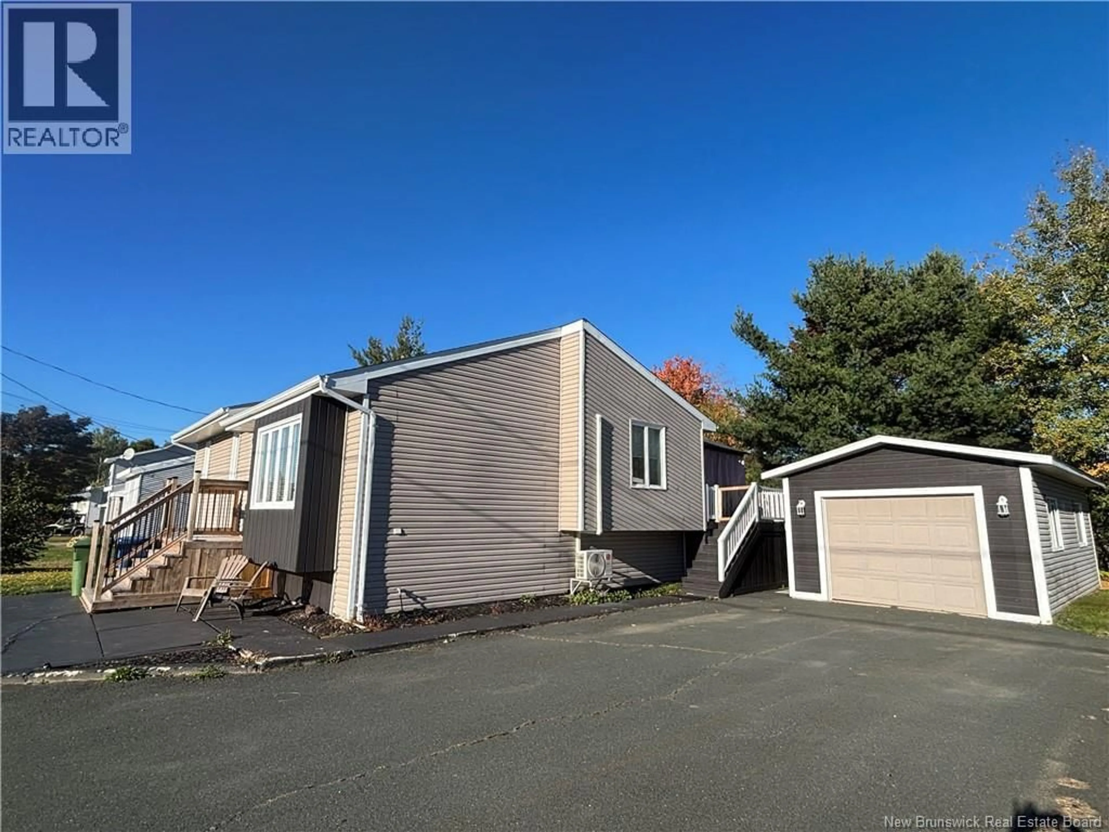 Home with vinyl exterior material, street for 1027 RUE HACHE, Beresford New Brunswick E8K1H9