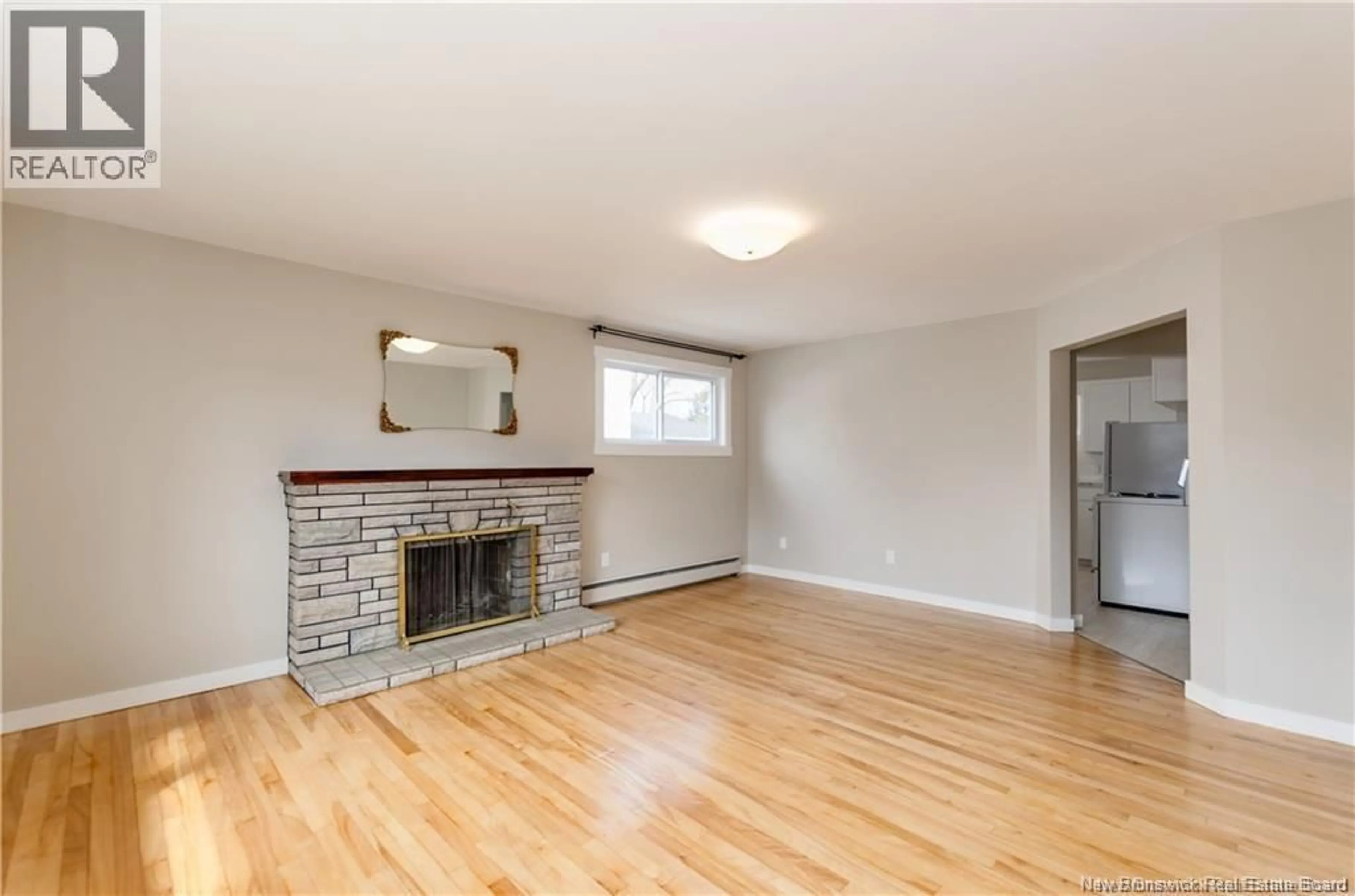 Living room with furniture, wood/laminate floor for 93 EDWARD, Moncton New Brunswick E1A3Z1