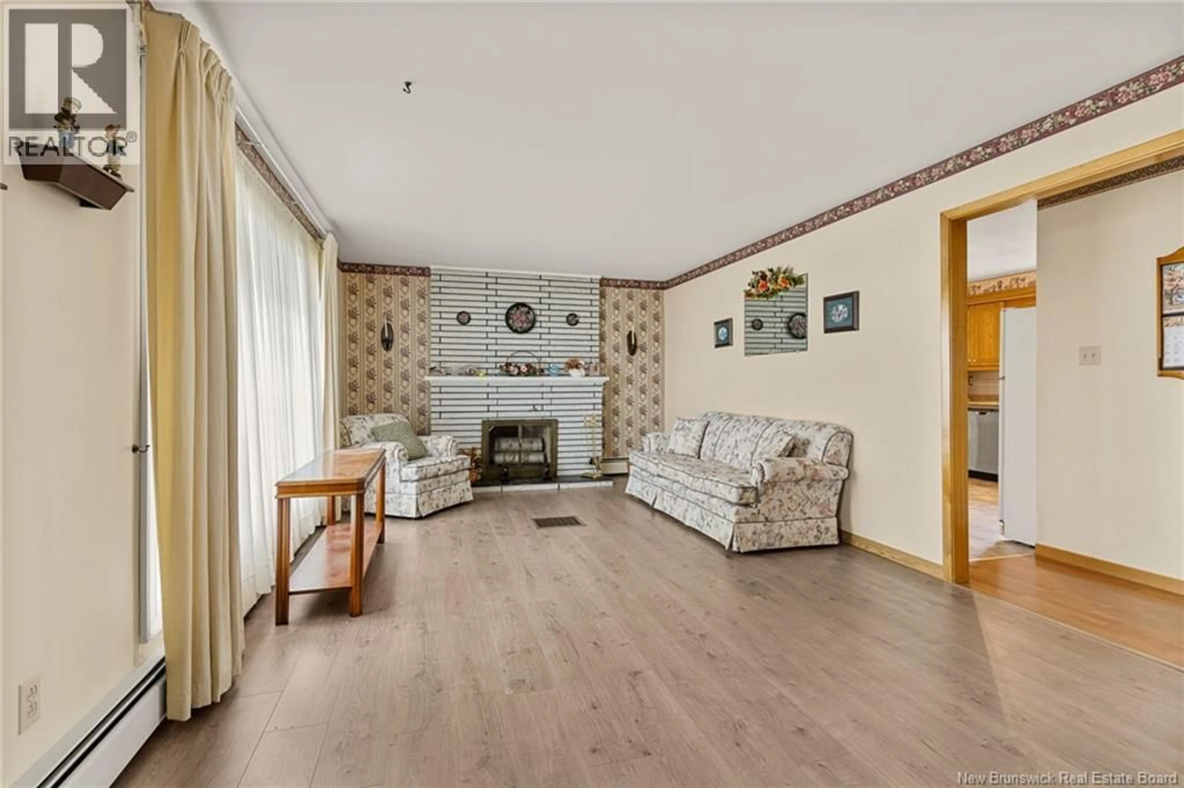 Living room with furniture, wood/laminate floor for 1802 CHAMPLAIN STREET, Dieppe New Brunswick E1A7J1