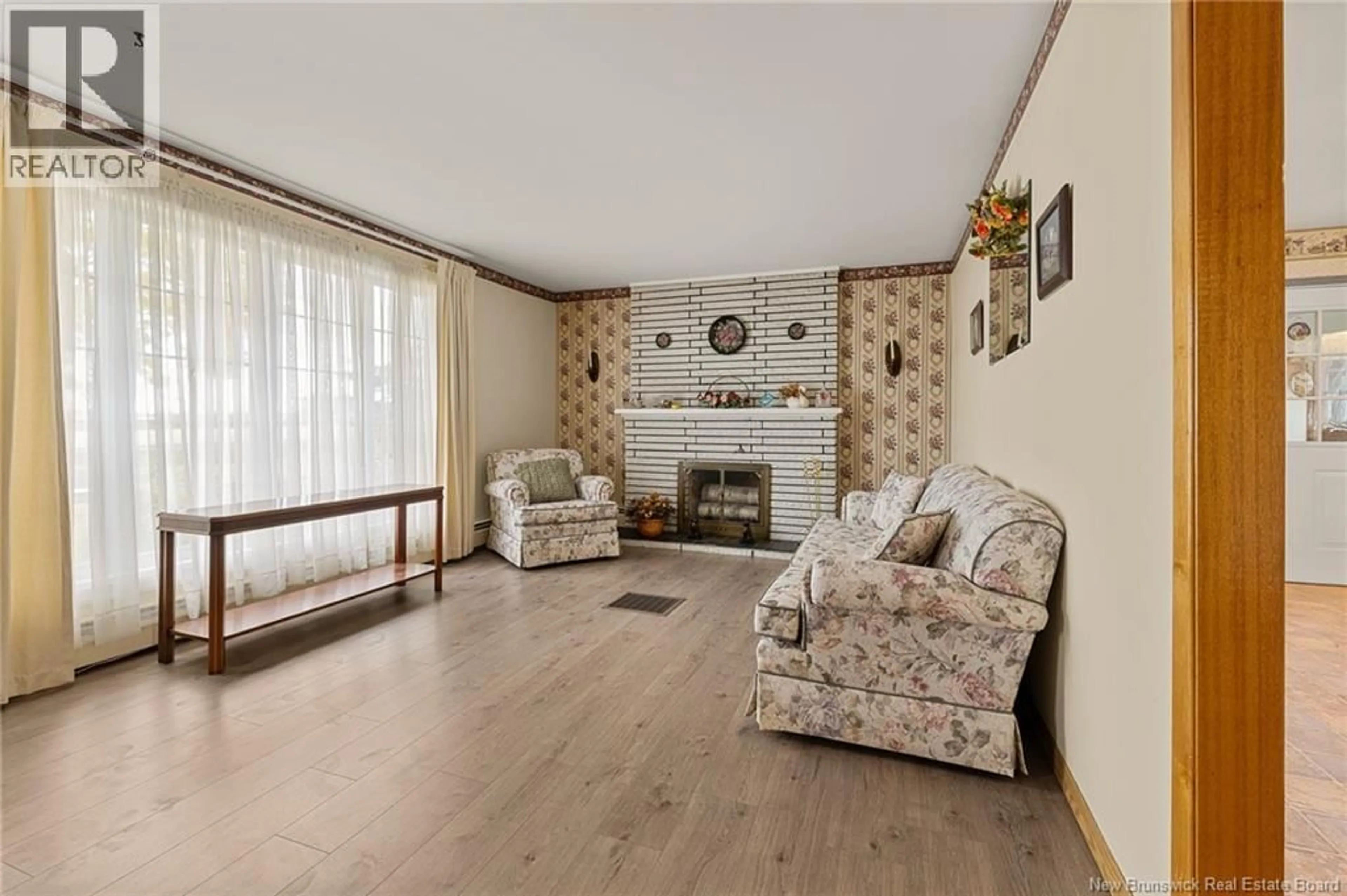 Living room with furniture, wood/laminate floor for 1802 CHAMPLAIN STREET, Dieppe New Brunswick E1A7J1