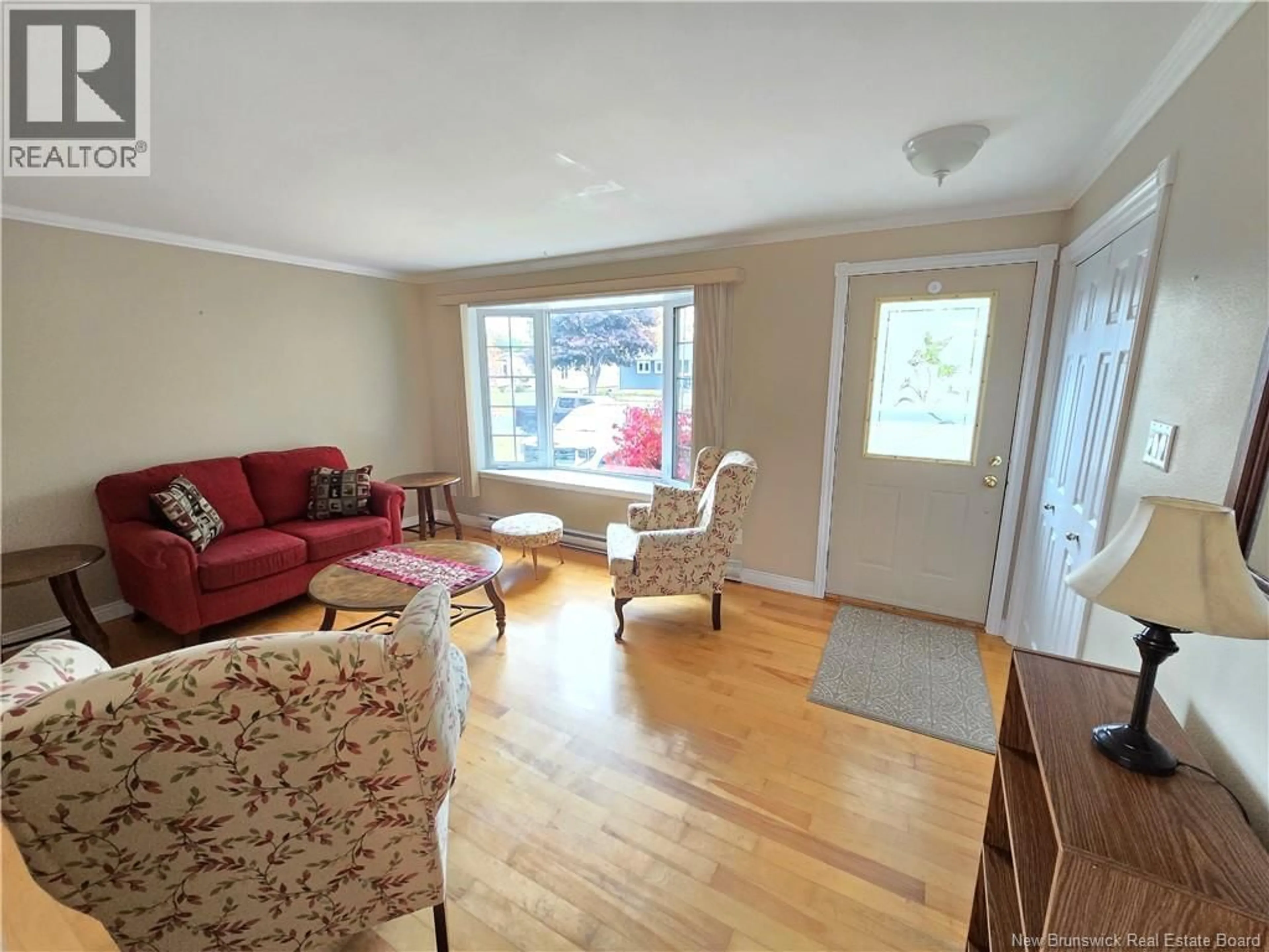 Living room with furniture, wood/laminate floor for 232 AIMEE STREET, Beresford New Brunswick E8K1L9
