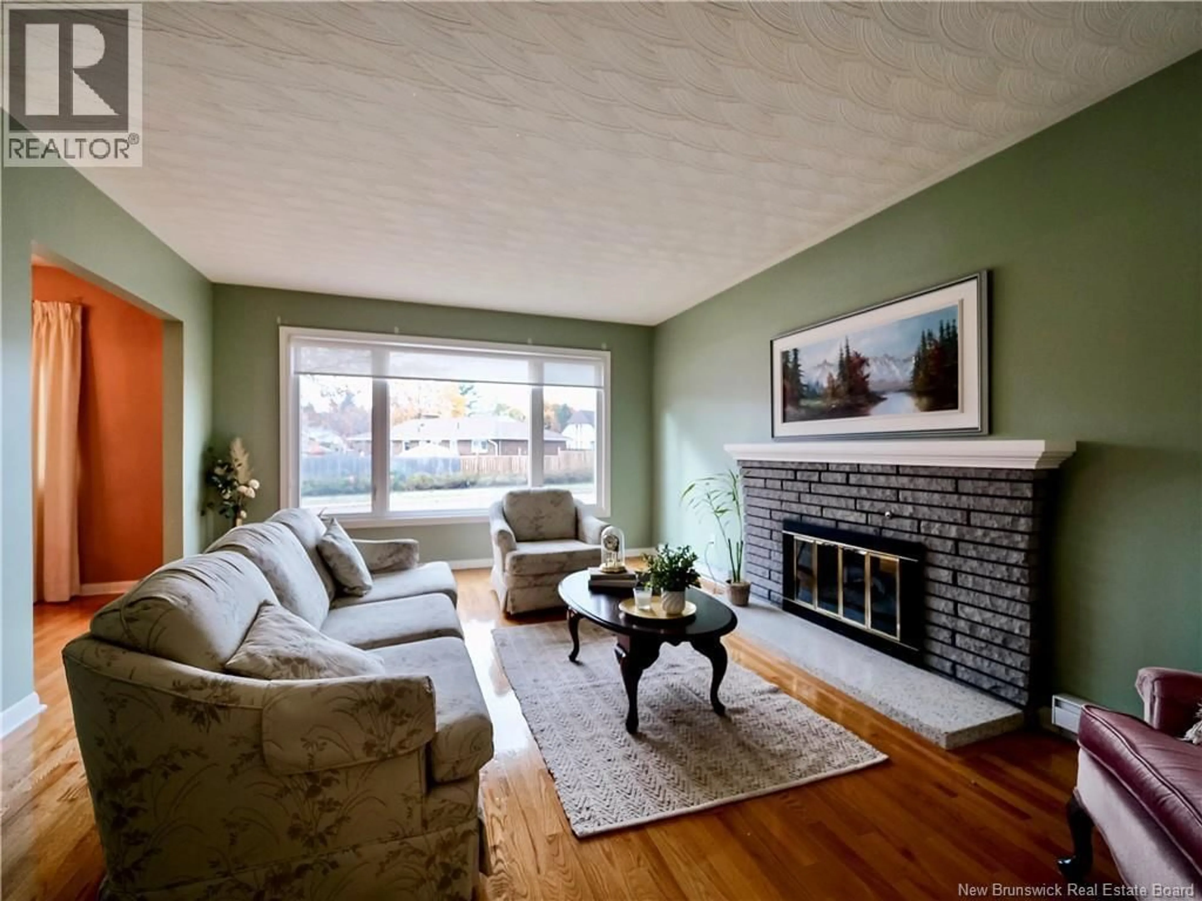 Living room with furniture, wood/laminate floor for 107 CARNEY, Moncton New Brunswick E1C4J1