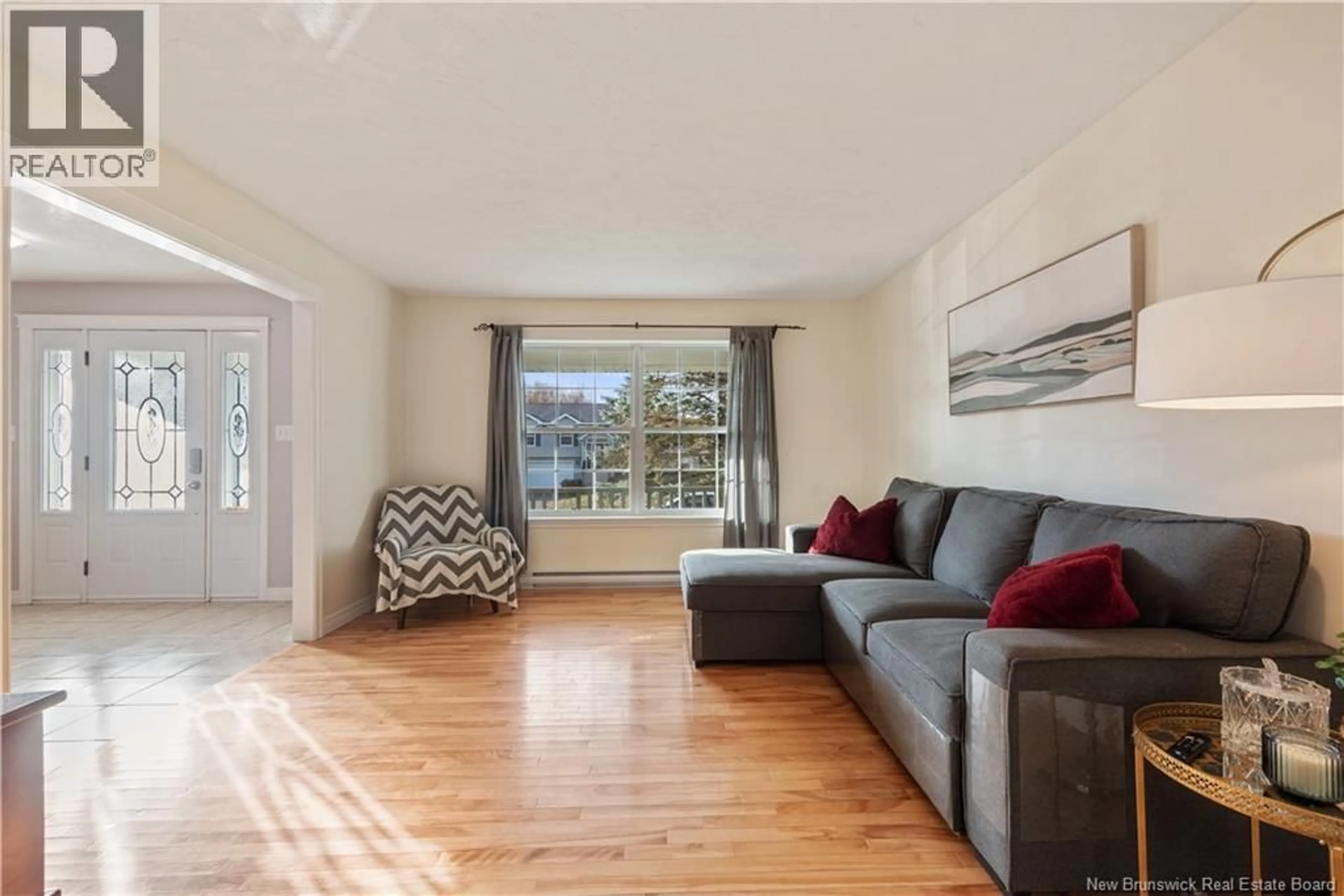Living room with furniture, wood/laminate floor for 67 LOTUSROW DRIVE, Moncton New Brunswick E1E4X1