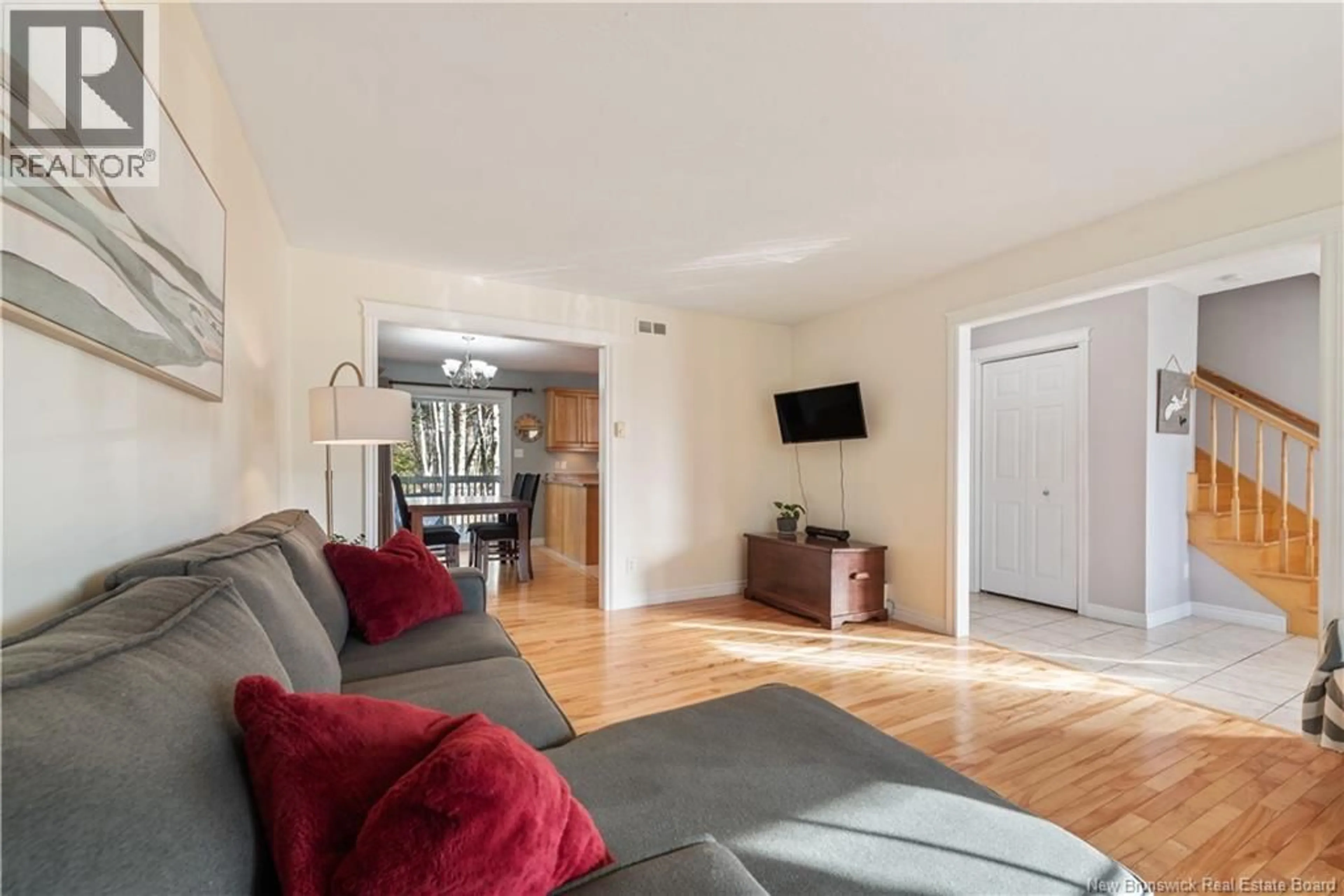 Living room with furniture, wood/laminate floor for 67 LOTUSROW DRIVE, Moncton New Brunswick E1E4X1