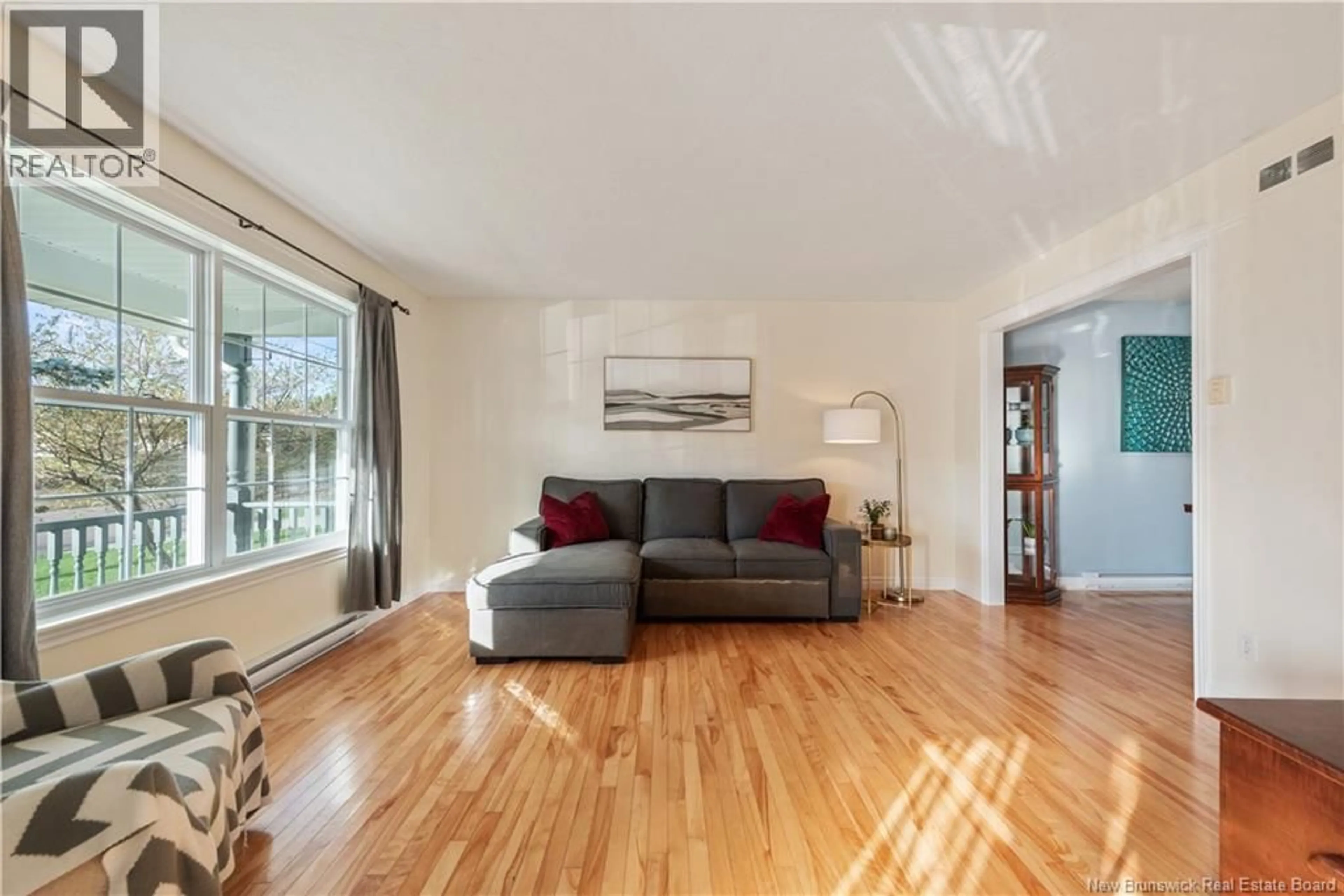Living room with furniture, wood/laminate floor for 67 LOTUSROW DRIVE, Moncton New Brunswick E1E4X1