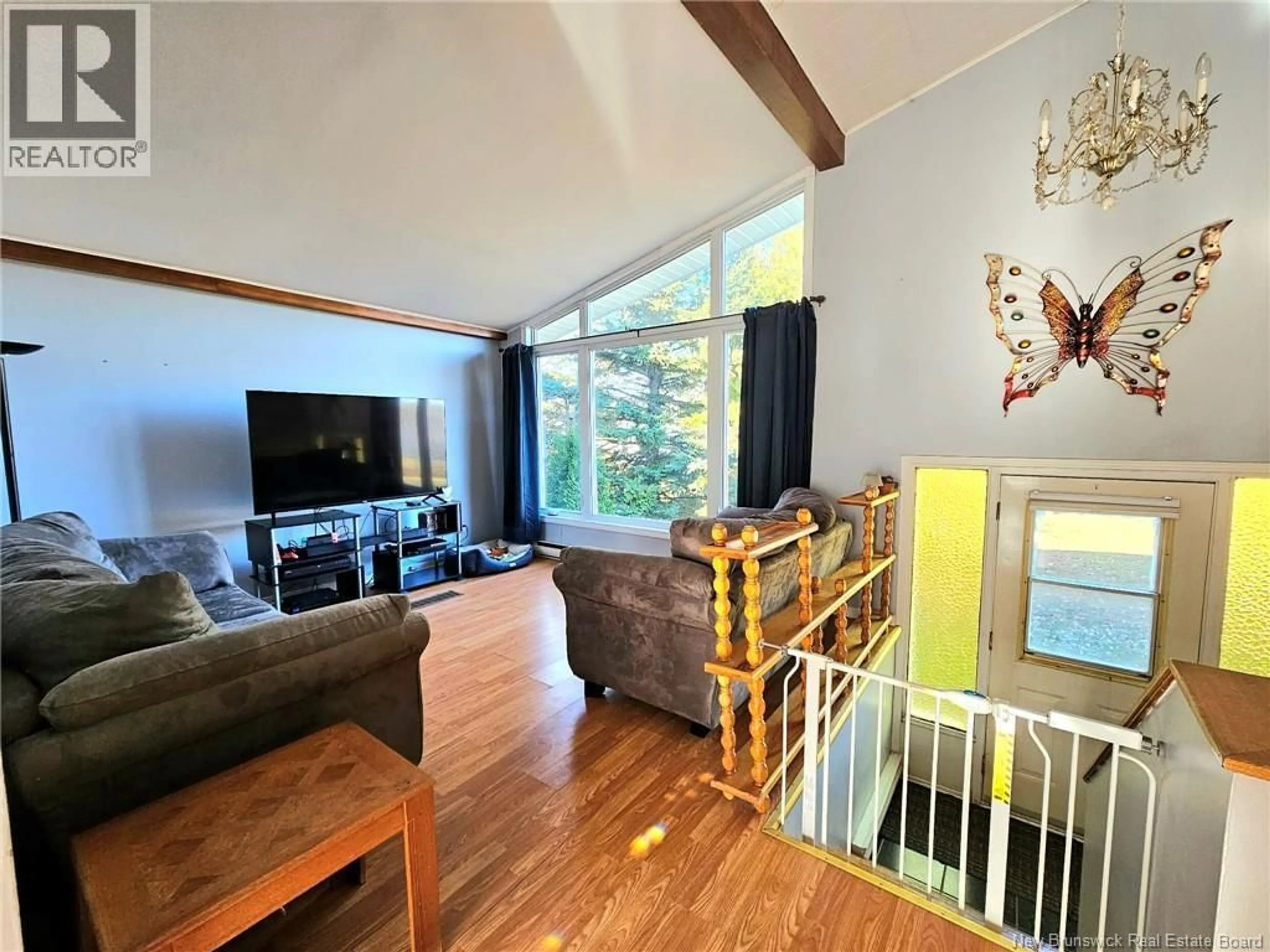 Living room with furniture, wood/laminate floor for 329 RUE DU MOULIN, Nigadoo New Brunswick E8K3M2