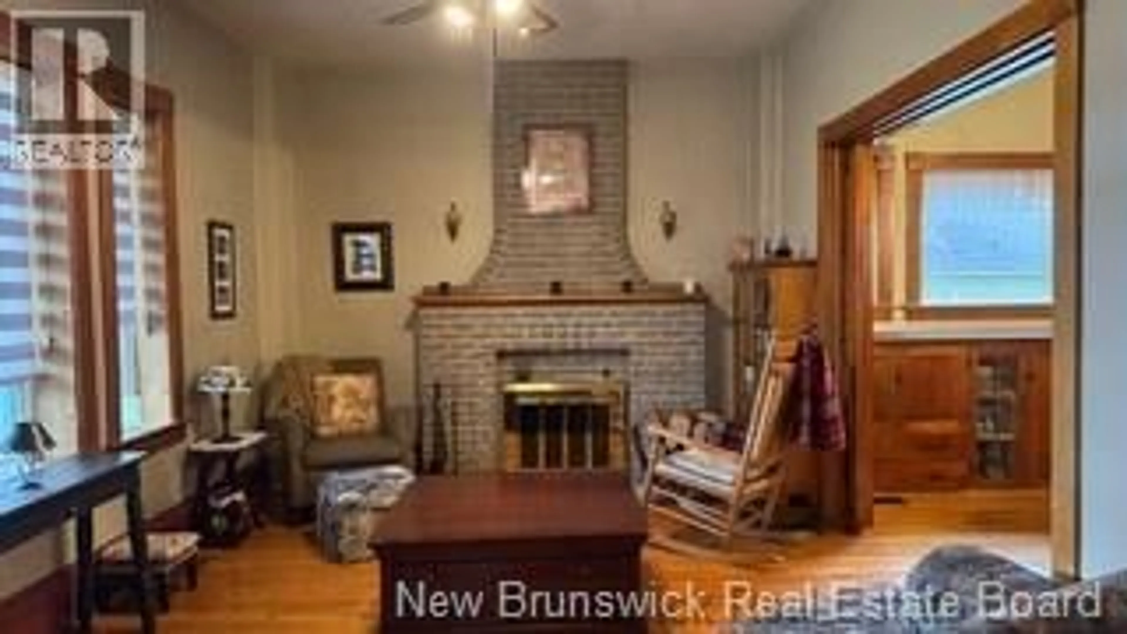 Living room with furniture, wood/laminate floor for 22 CYR STREET, Saint-Léonard New Brunswick E7E1X7