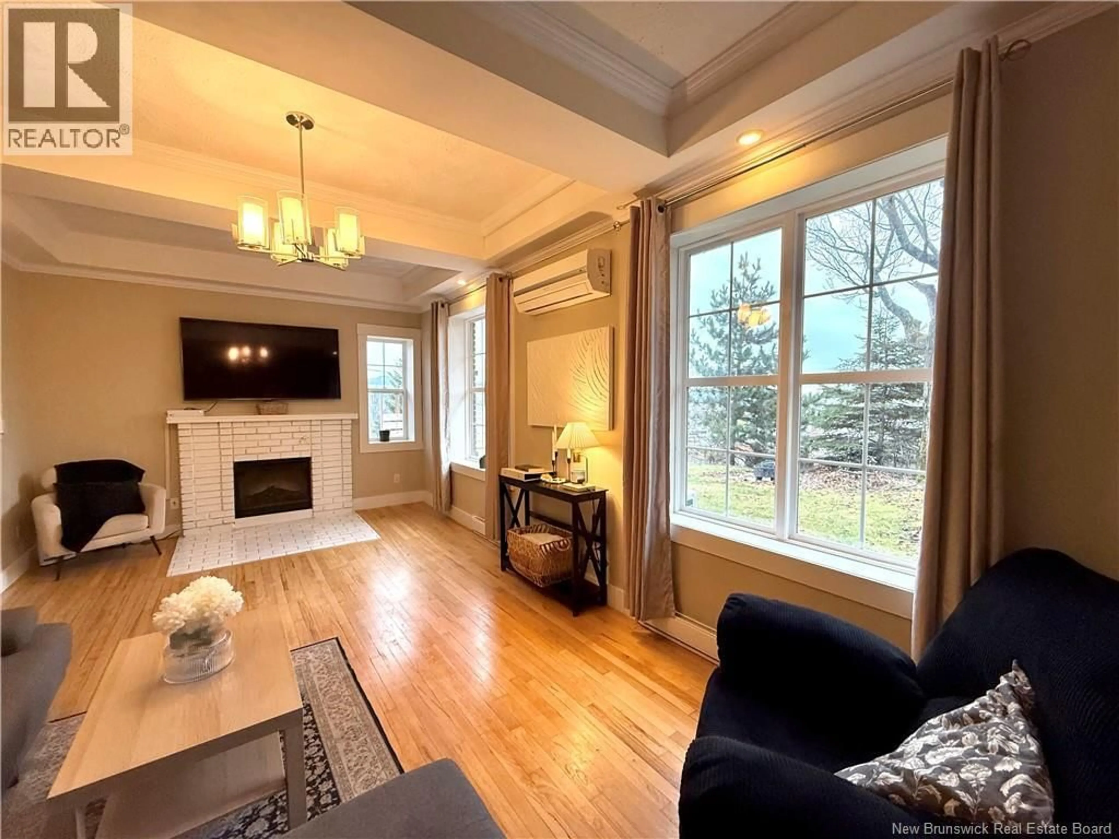 Living room with furniture, wood/laminate floor for 8 CONWAY STREET, Edmundston New Brunswick E3V1Z1