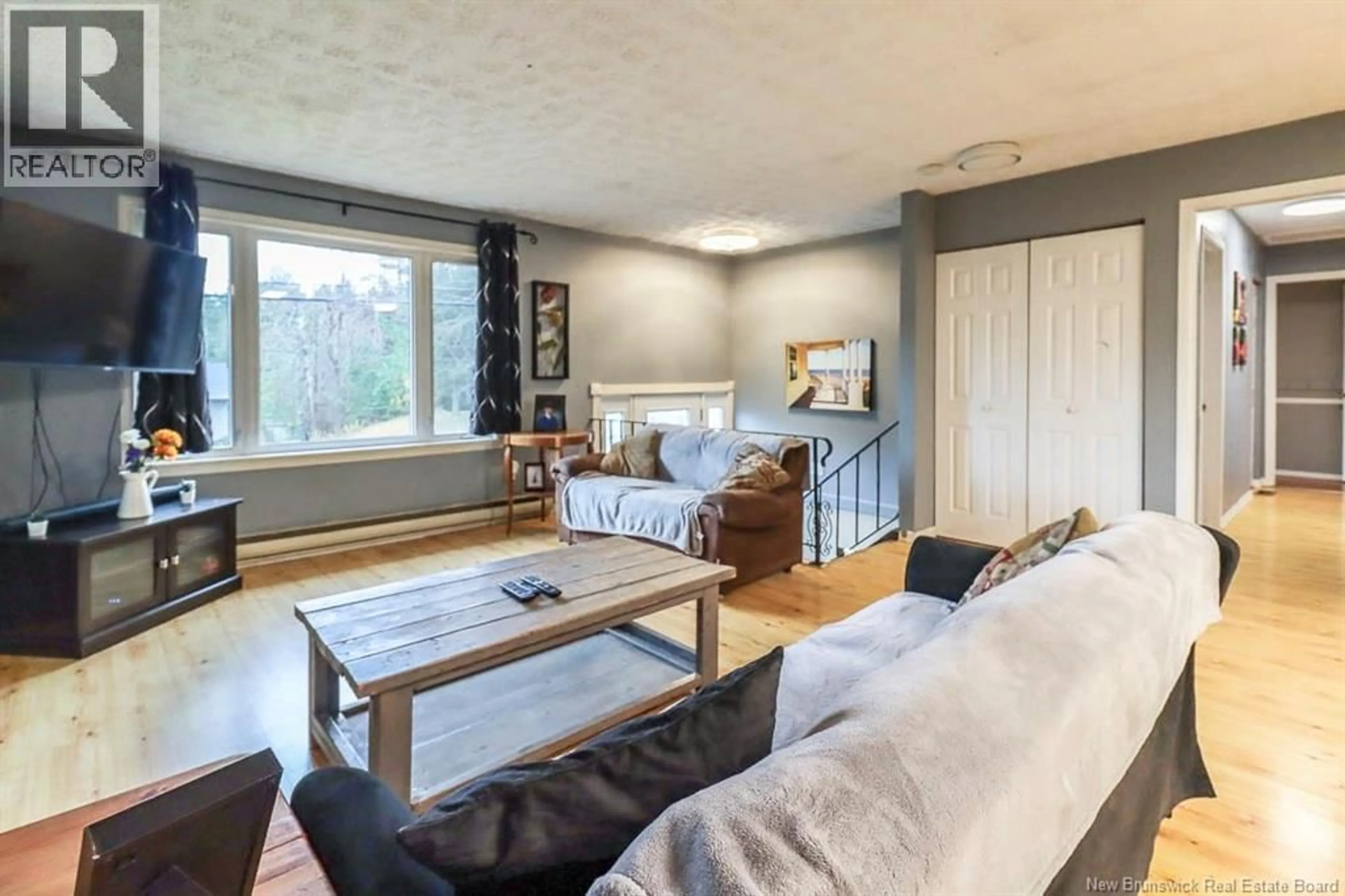 Living room with furniture, wood/laminate floor for 57 MONARCH DRIVE, Quispamsis New Brunswick E2G1P2