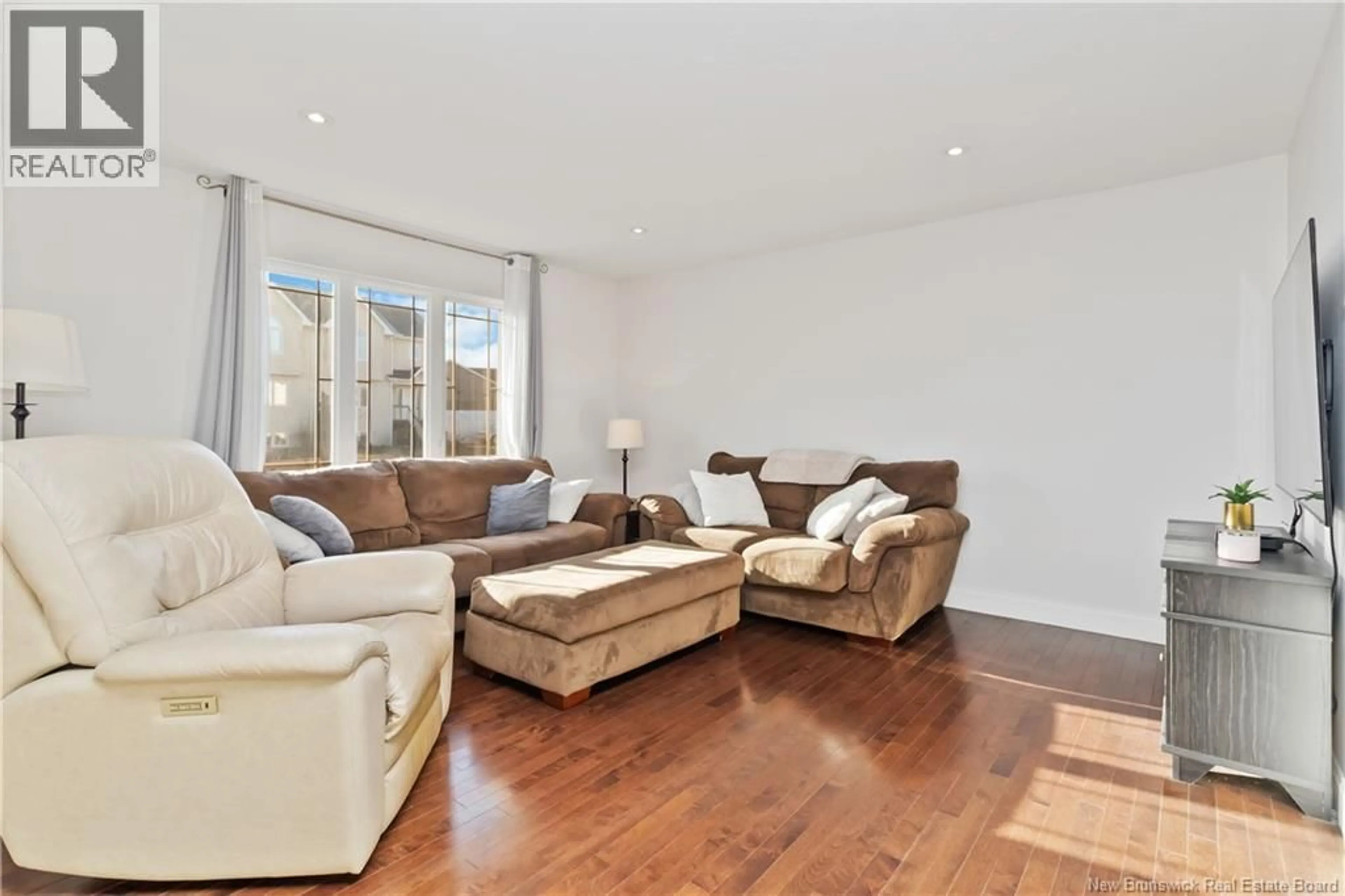 Living room with furniture, wood/laminate floor for 143 CORIANDER STREET, Moncton New Brunswick E1G0R9