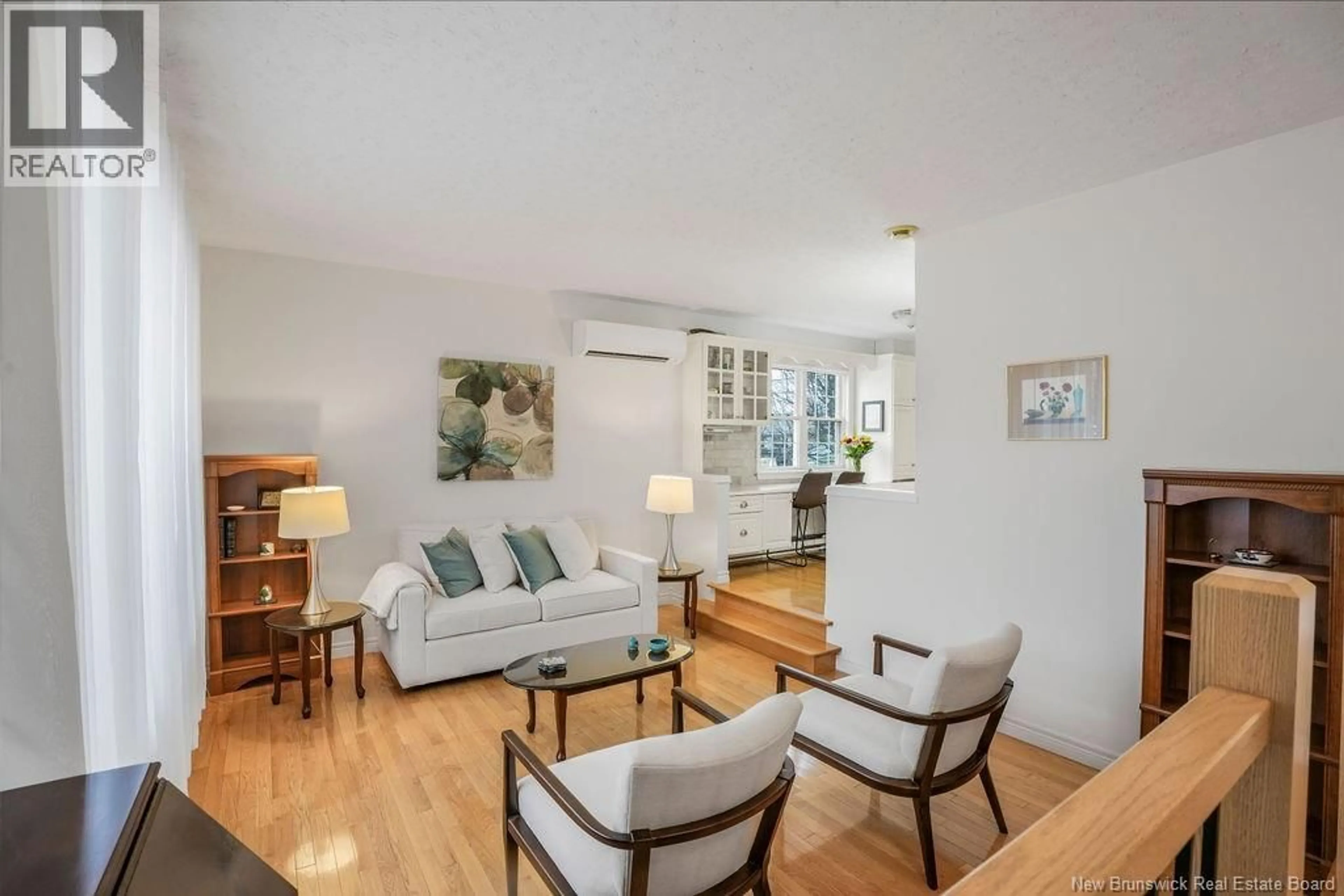 Living room with furniture, wood/laminate floor for 49 WOODMOUNT DRIVE, Fredericton New Brunswick E3A2M2