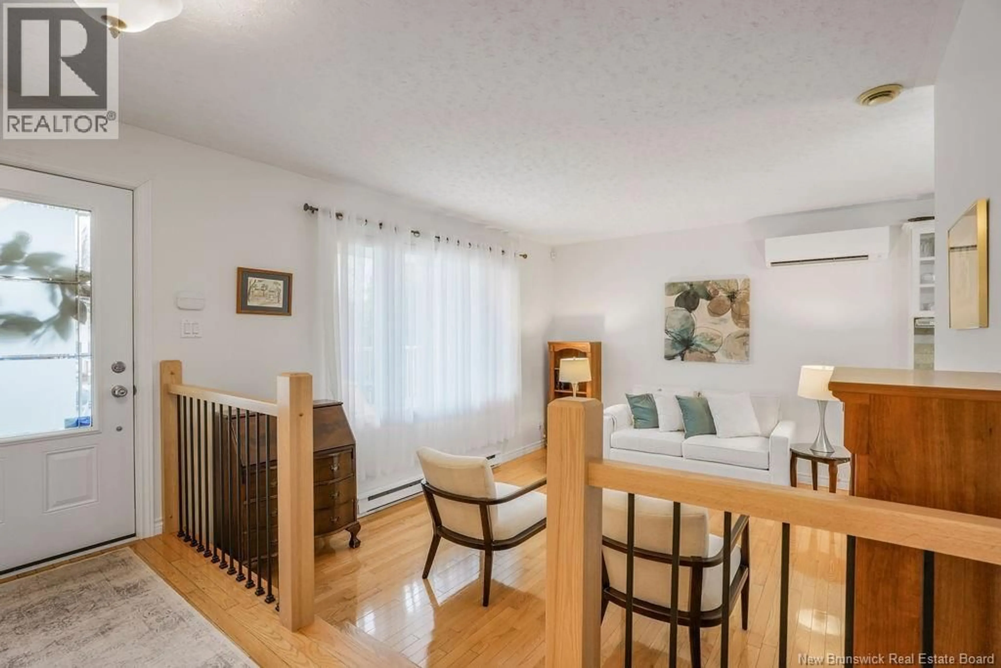 Living room with furniture, wood/laminate floor for 49 WOODMOUNT DRIVE, Fredericton New Brunswick E3A2M2