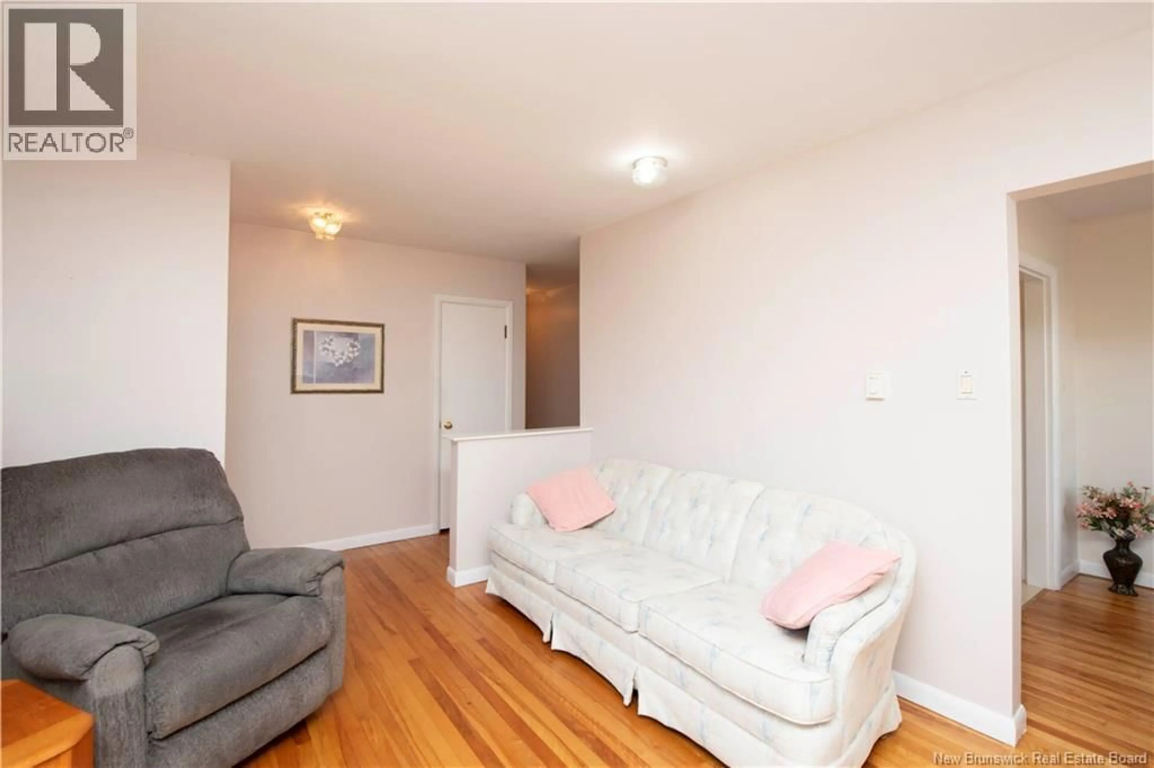 Living room with furniture, wood/laminate floor for 48 CORONATION DRIVE, Moncton New Brunswick E1E2X1