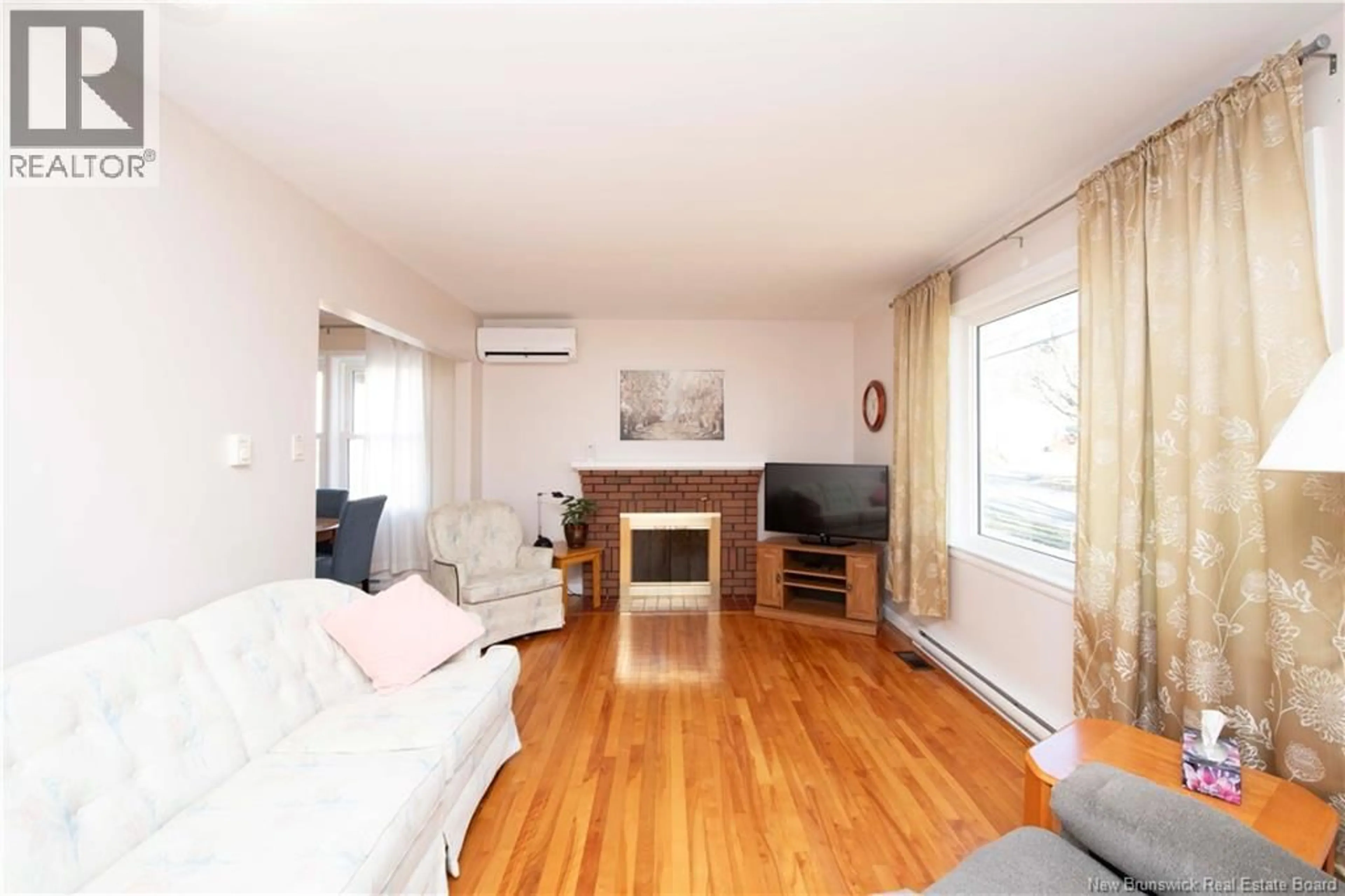Living room with furniture, wood/laminate floor for 48 CORONATION DRIVE, Moncton New Brunswick E1E2X1