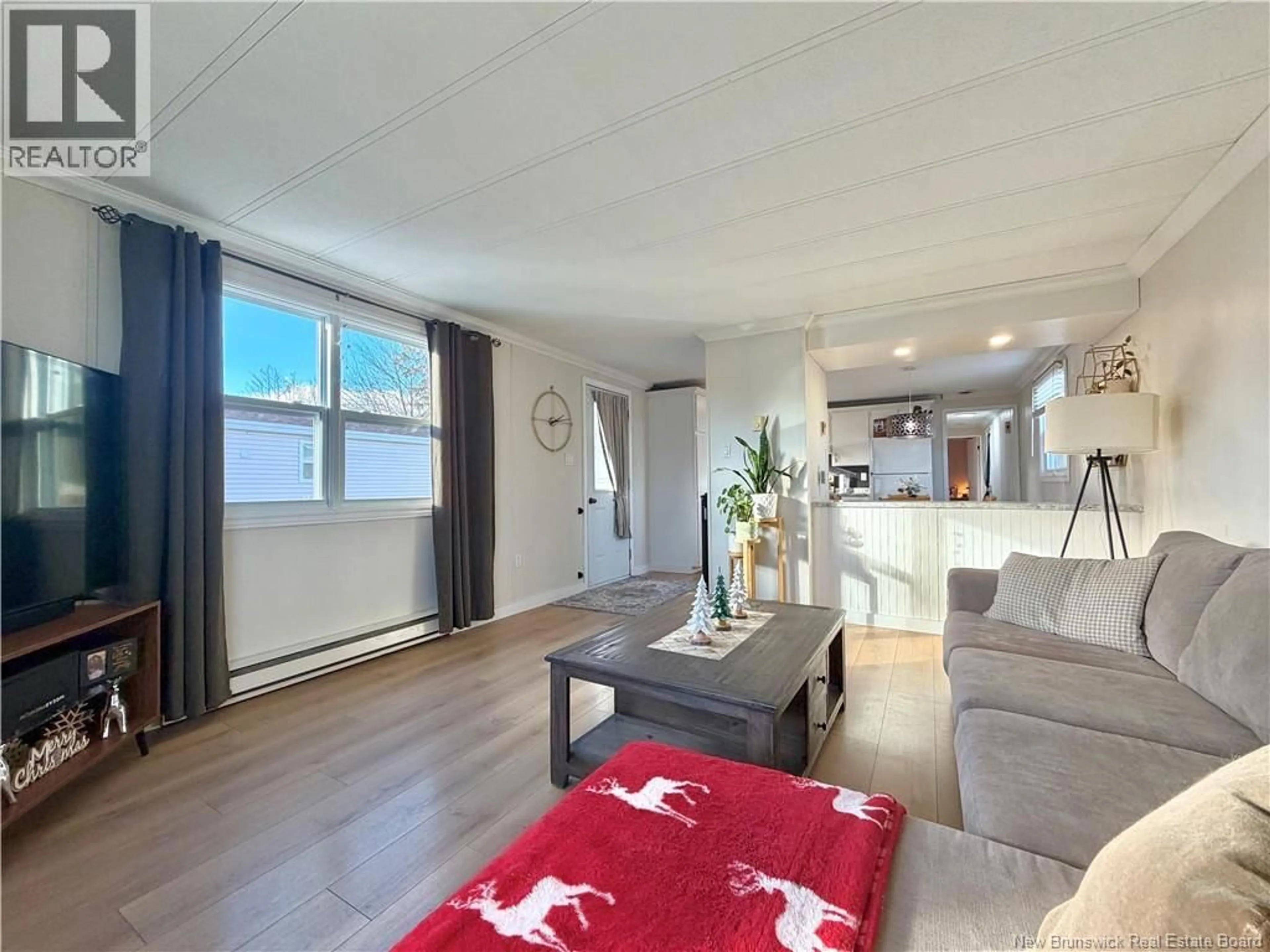 Living room with furniture, wood/laminate floor for 230 BIRCHGROVE ROAD, Beresford New Brunswick E8K1G7