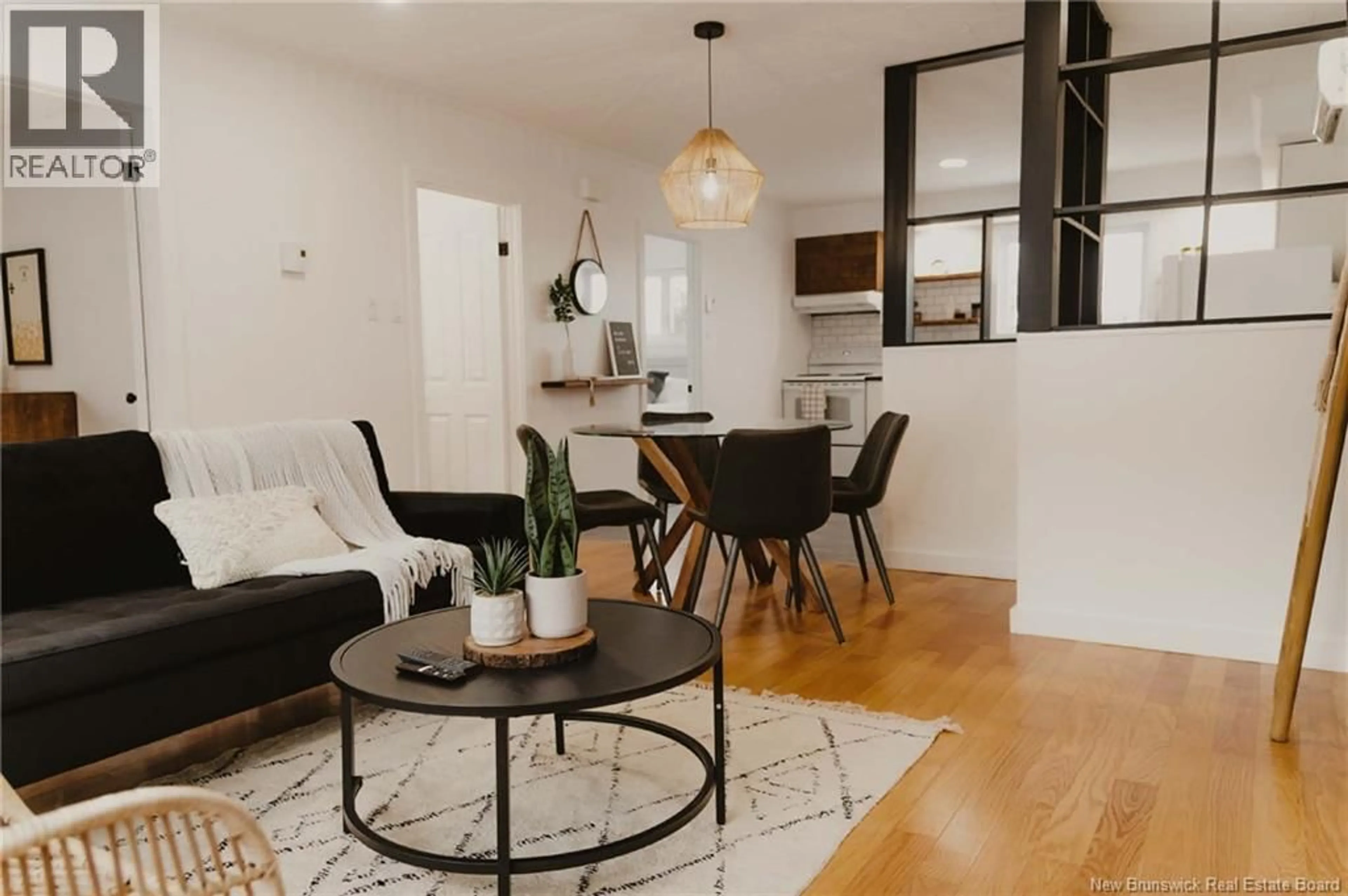 Living room with furniture, wood/laminate floor for 209 ST LOUIS STREET, Atholville New Brunswick E3N4C2
