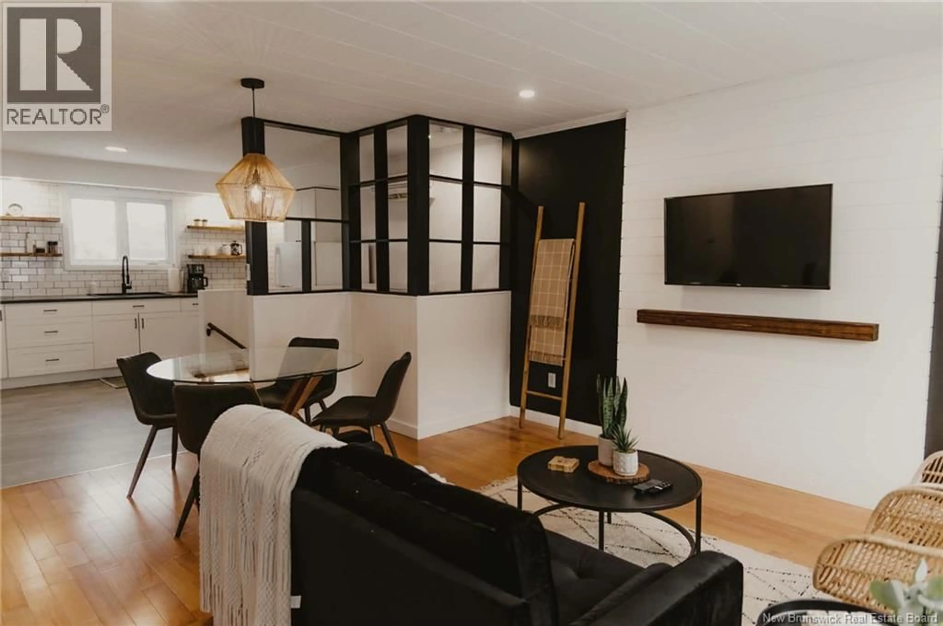 Living room with furniture, wood/laminate floor for 209 ST LOUIS STREET, Atholville New Brunswick E3N4C2