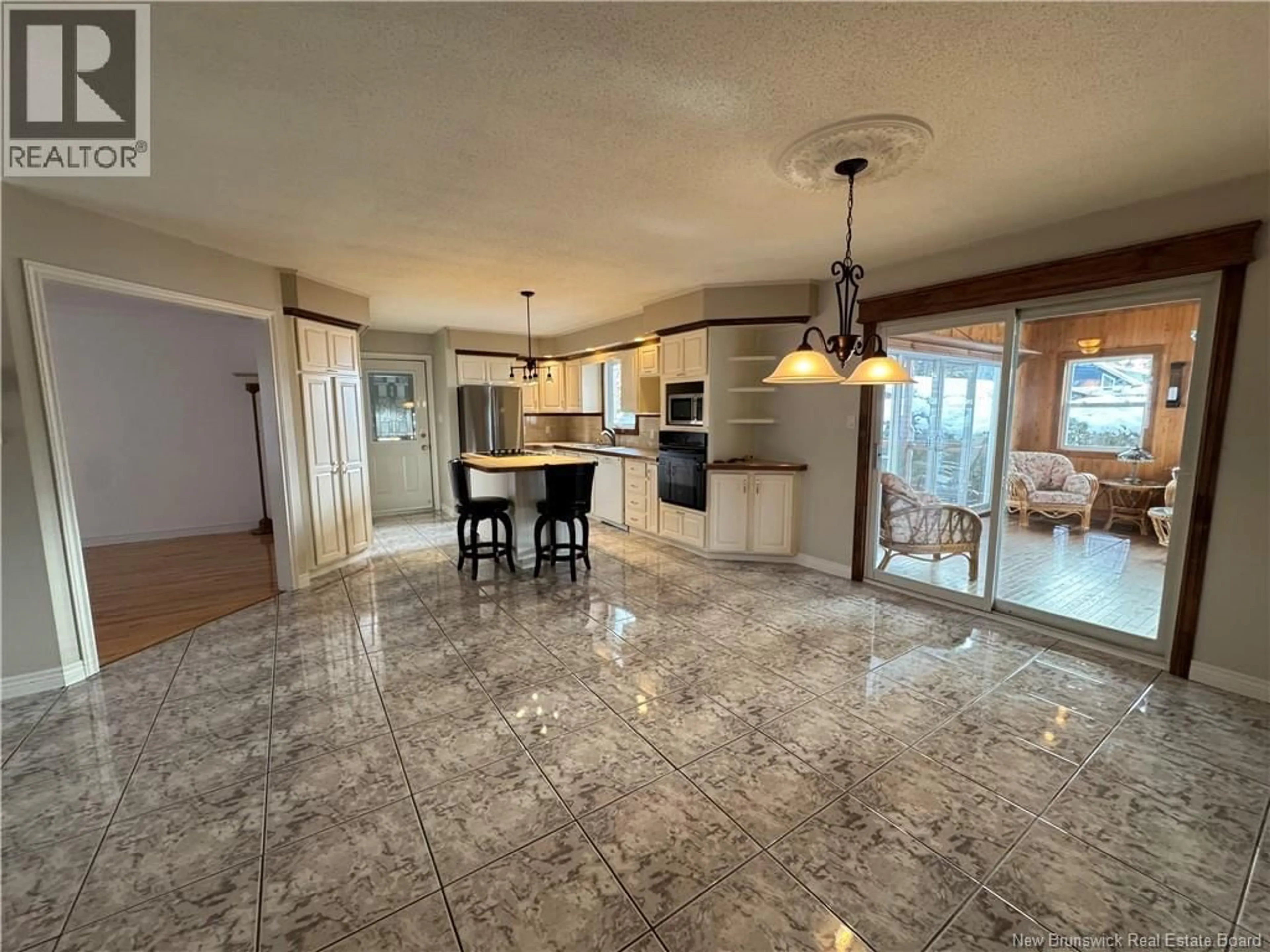 Open concept kitchen, ceramic/tile floor for 17 RUE BEAUSÉJOUR, Saint-Quentin New Brunswick E8A1B7