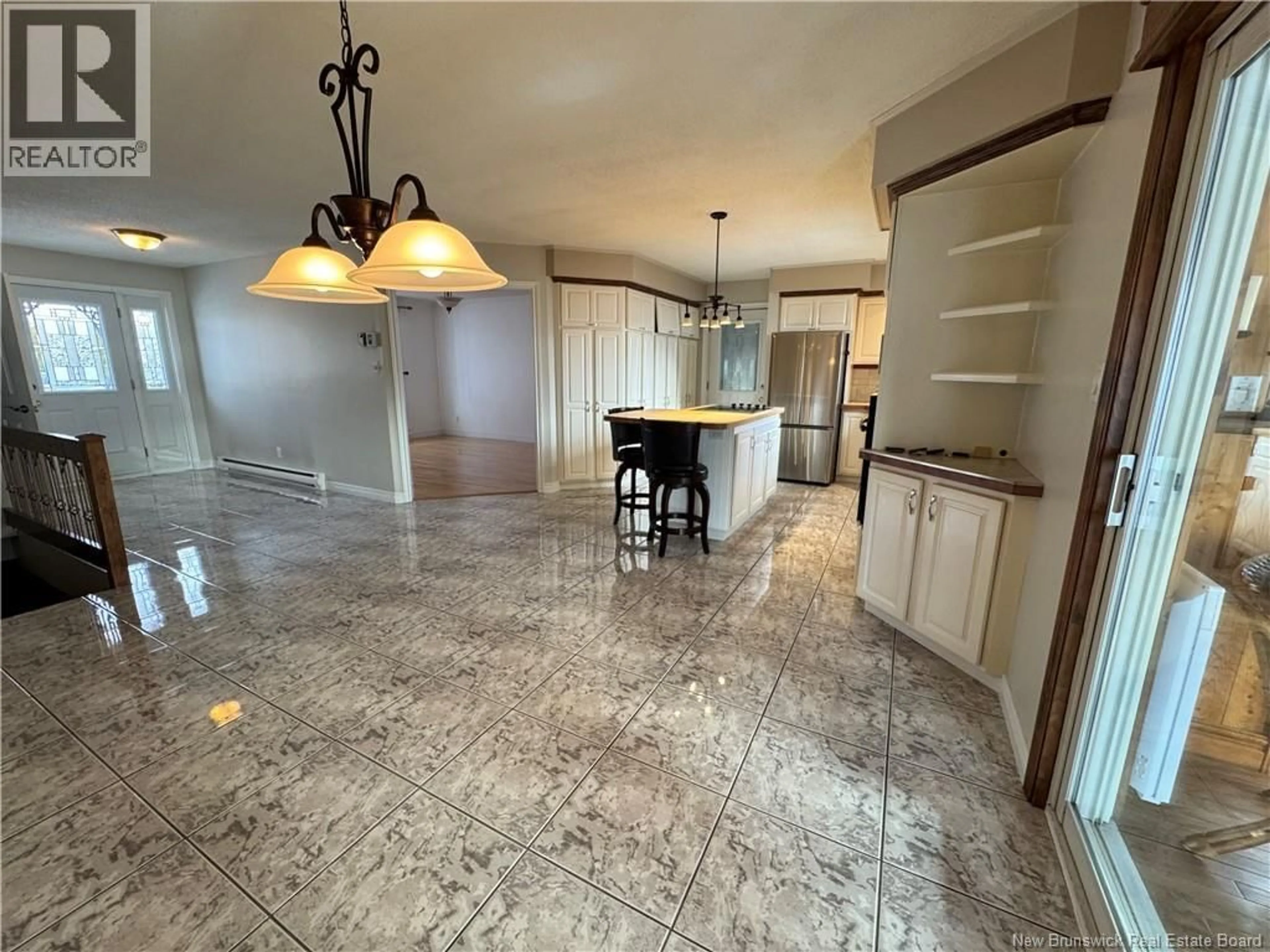 Open concept kitchen, ceramic/tile floor for 17 RUE BEAUSÉJOUR, Saint-Quentin New Brunswick E8A1B7