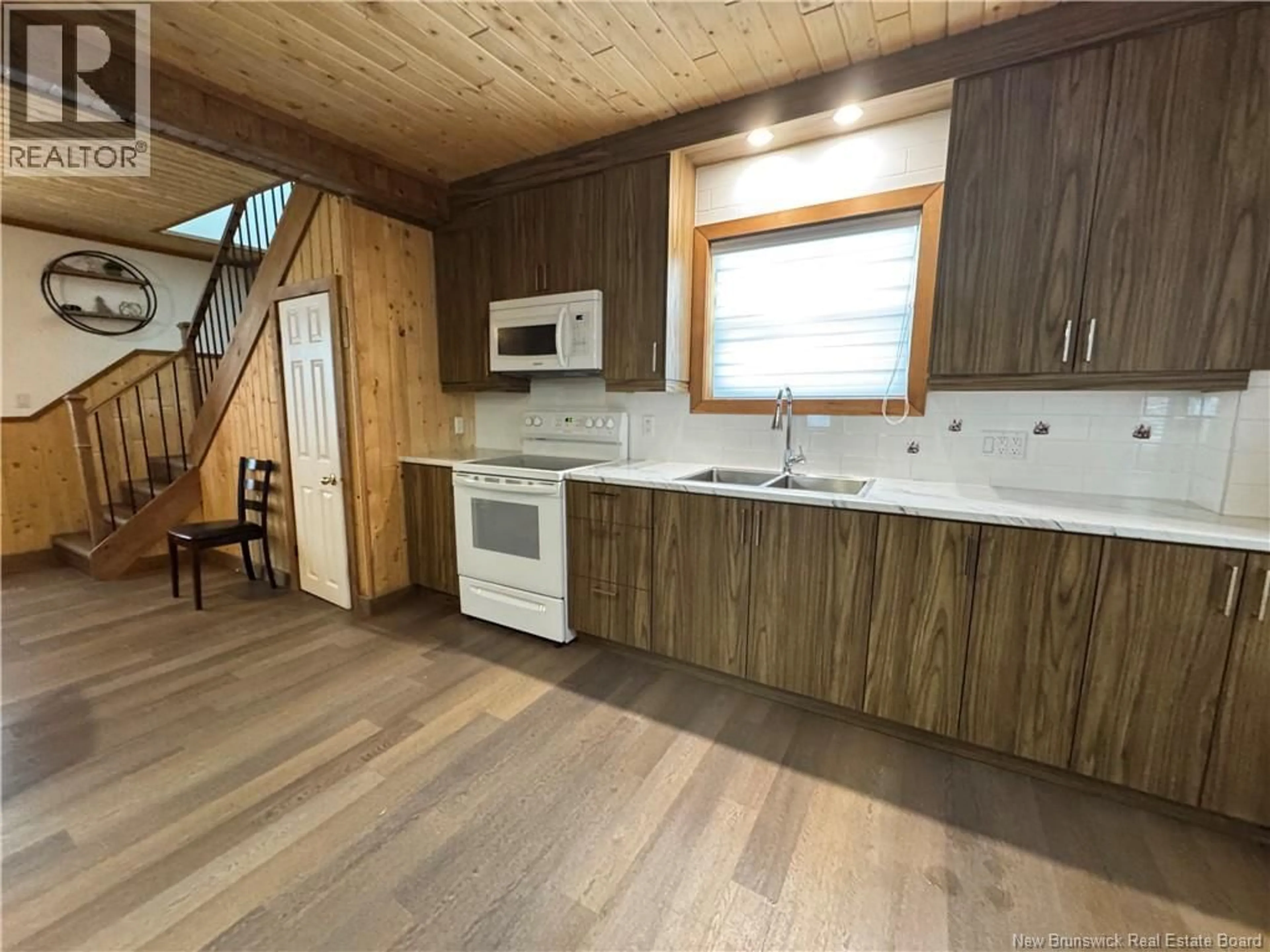 Open concept kitchen, wood/laminate floor for 30 ÉVANGÉLINE STREET, Saint-Quentin New Brunswick E8A1M6