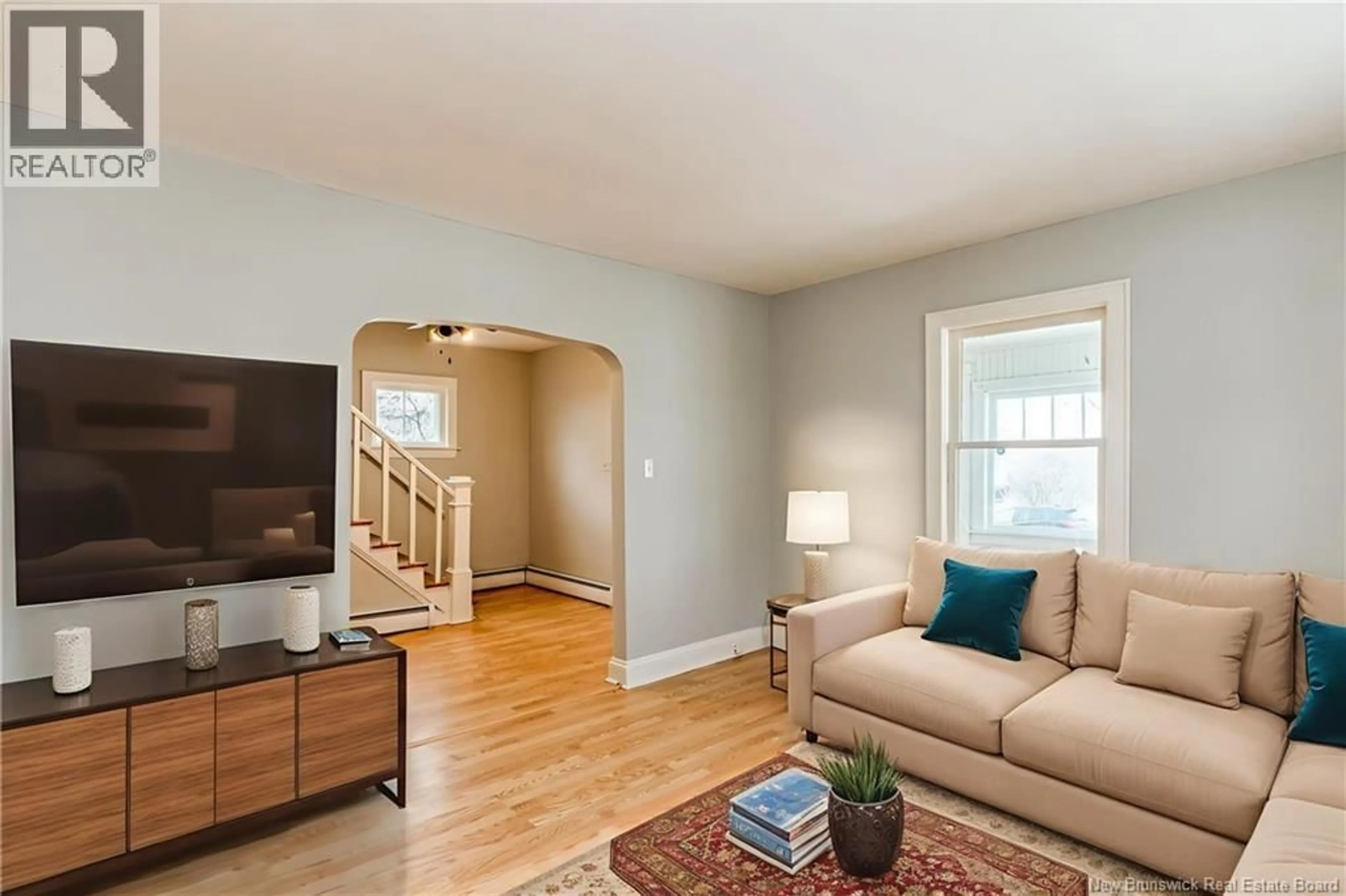 Living room with furniture, wood/laminate floor for 67 OAKLAND AVENUE, Moncton New Brunswick E1C7N9
