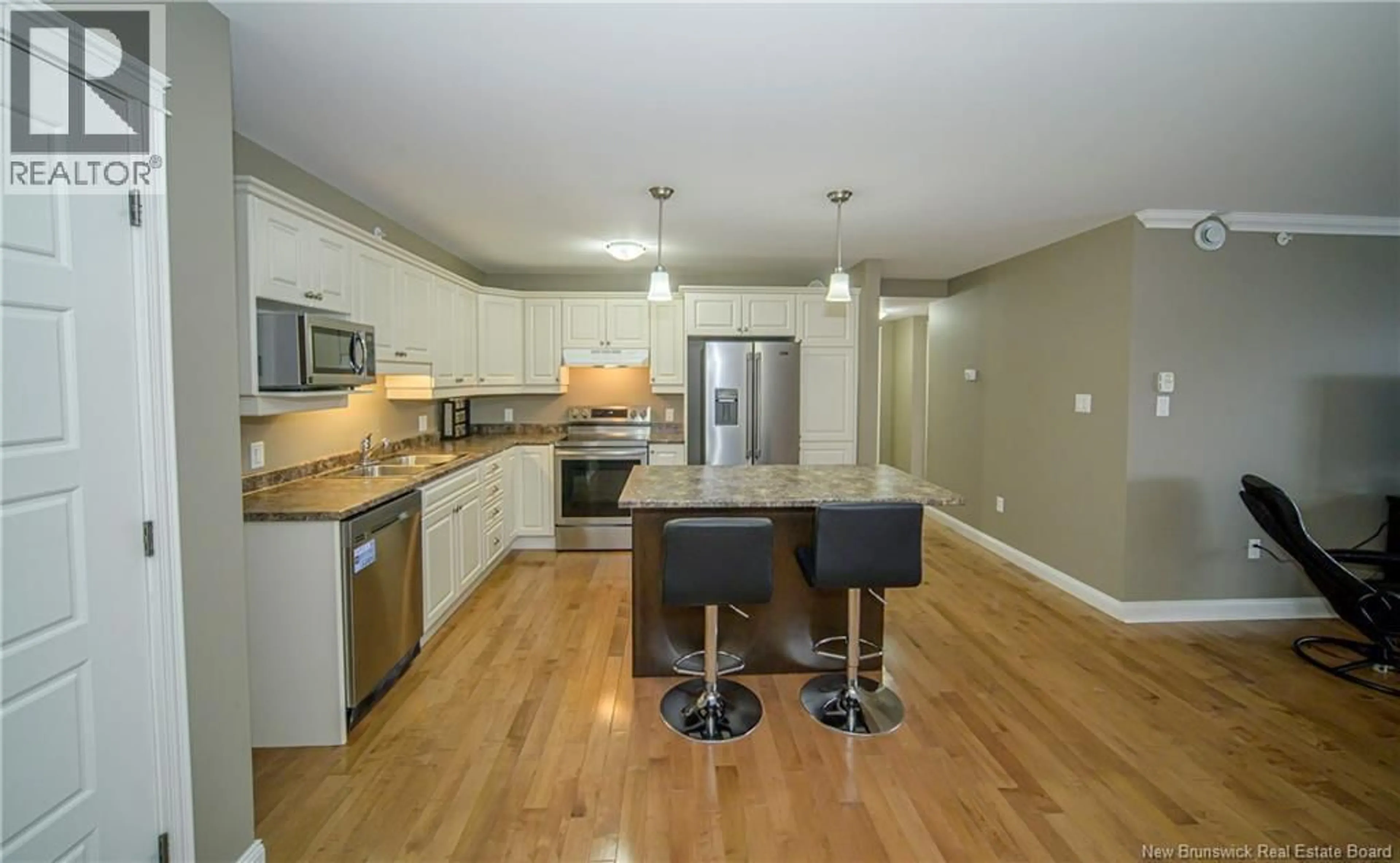 Open concept kitchen, wood/laminate floor for 409 - 65 BRAYSON BOULEVARD, Oromocto New Brunswick E2V0J2