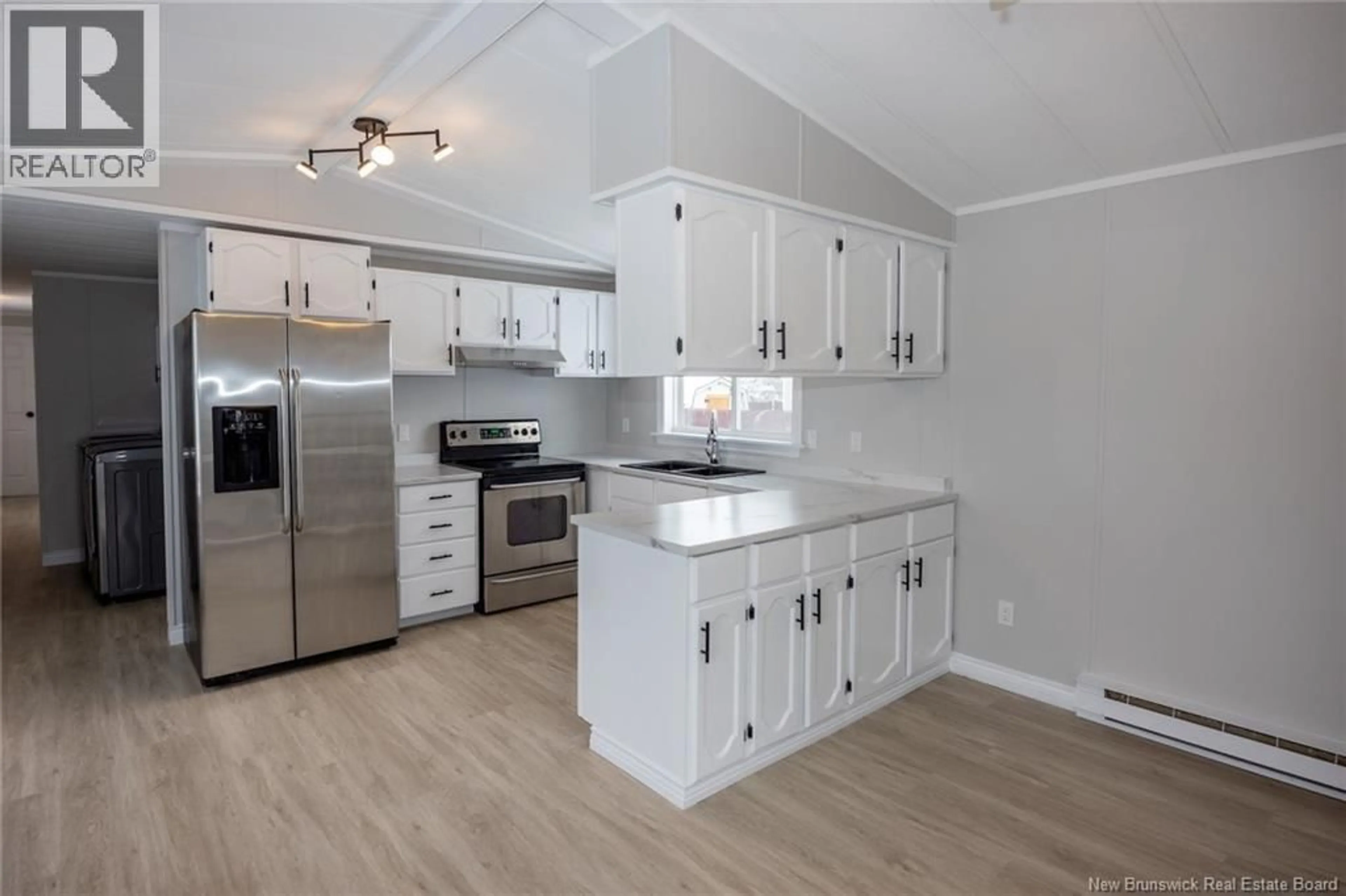 Open concept kitchen, wood/laminate floor for 24 TYLER STREET, Lincoln New Brunswick E3B6X3