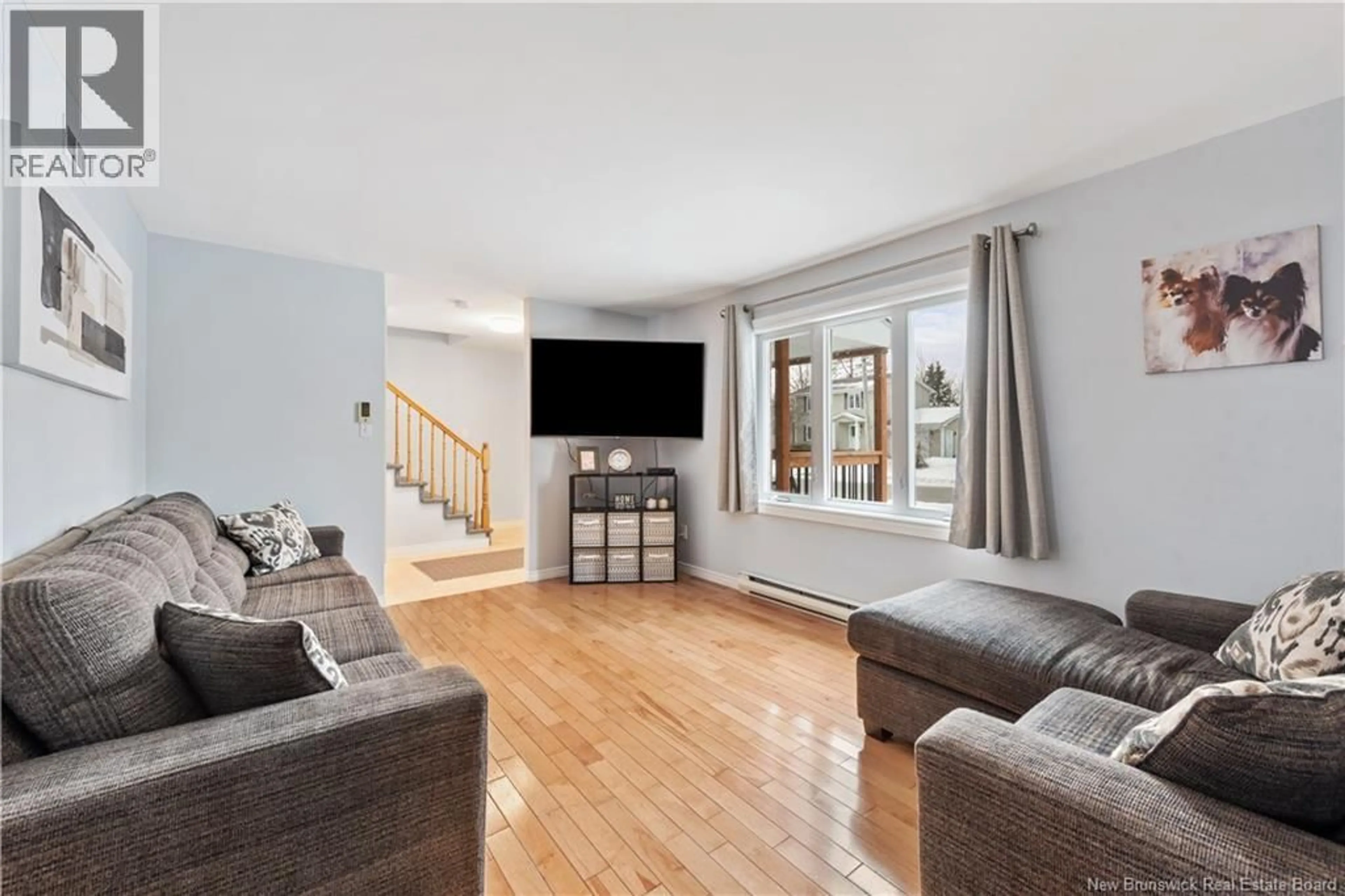 Living room with furniture, wood/laminate floor for 19 BRIDLEWOOD WAY, Moncton New Brunswick E1G2H2