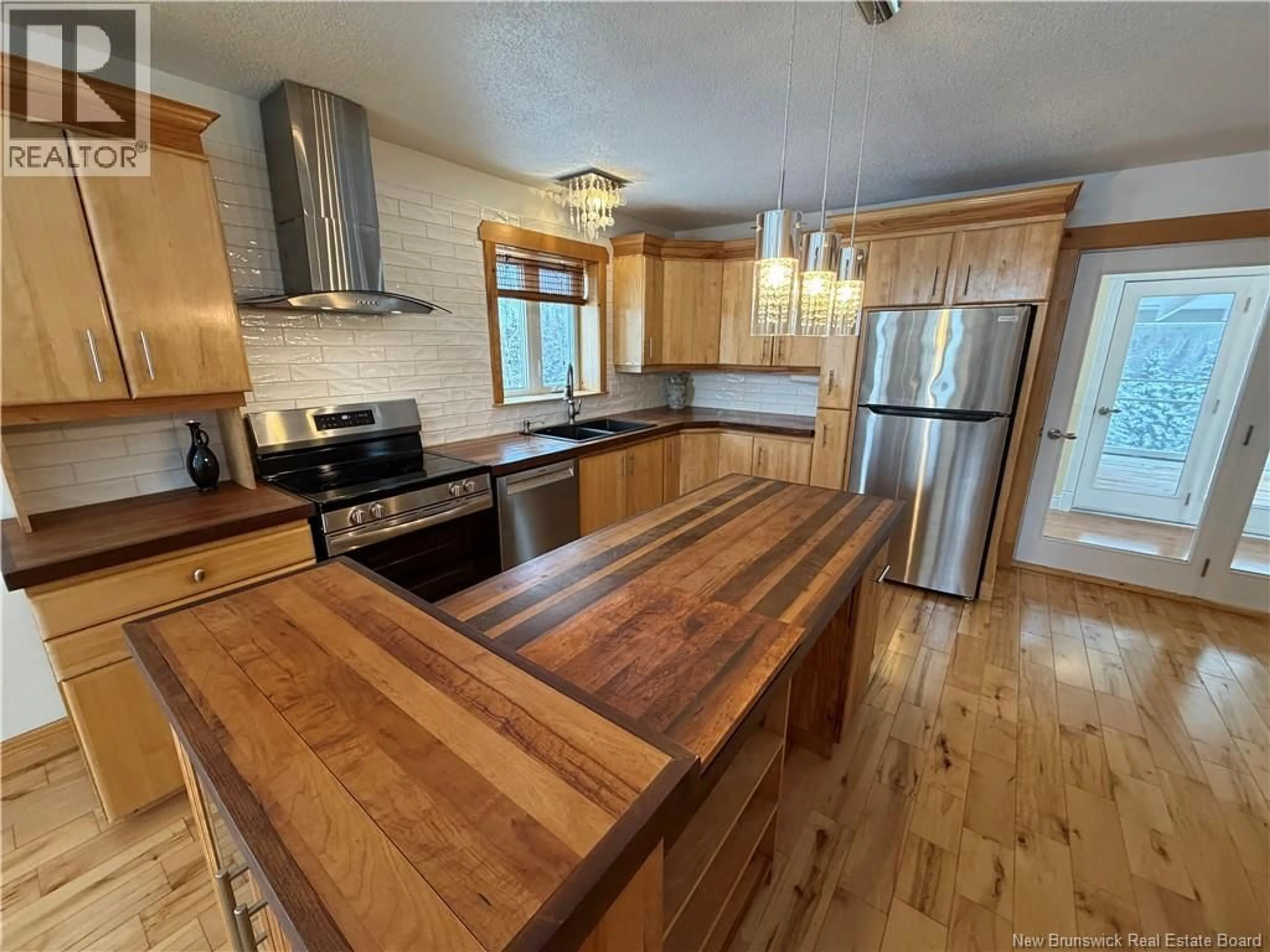 Open concept kitchen, wood/laminate floor for 2104 CORMIER, Sainte-Louise New Brunswick E8K2X6