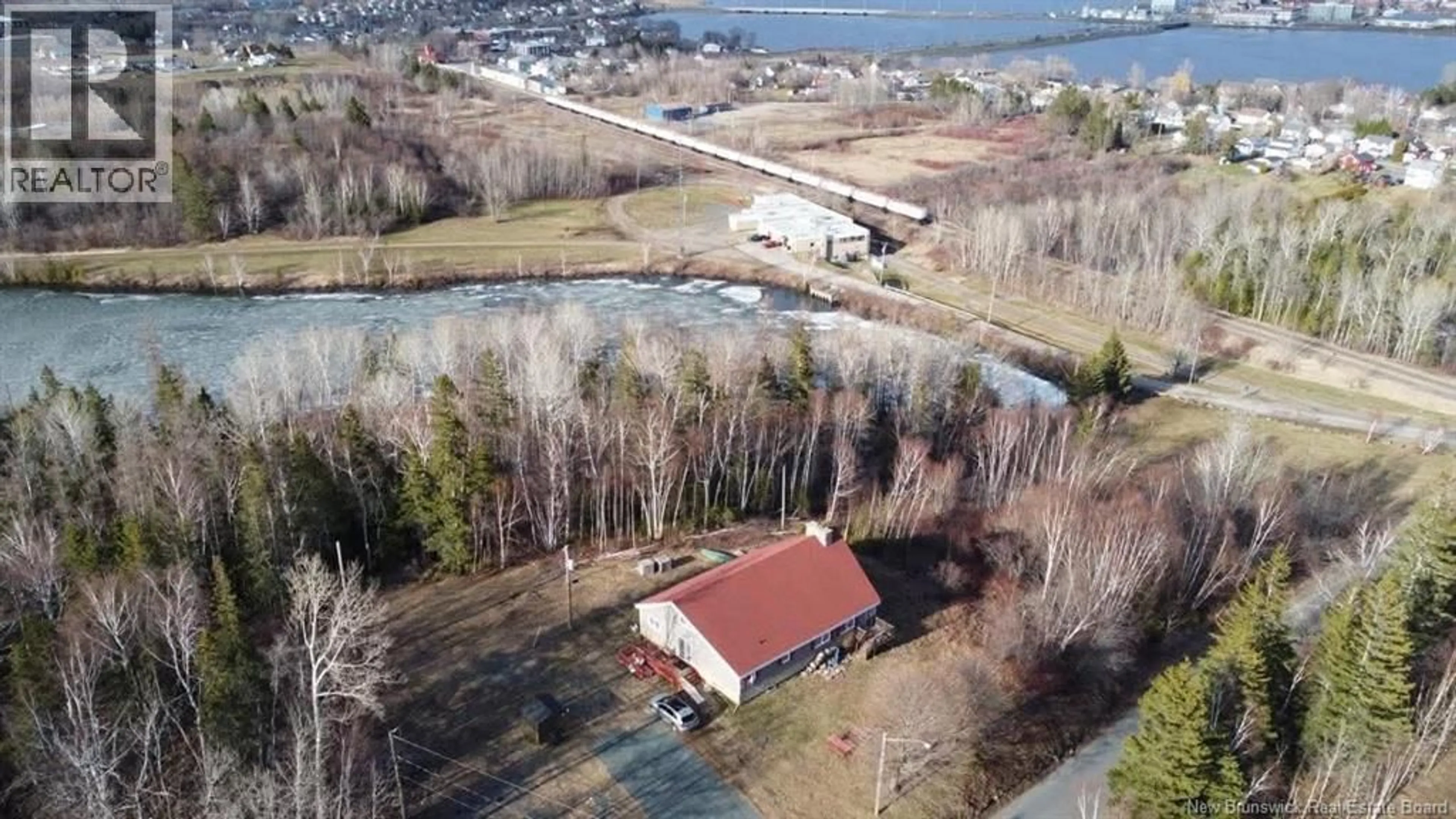 A pic from outside/outdoor area/front of a property/back of a property/a pic from drone, water/lake/river/ocean view for 716 GOLF STREET, Bathurst New Brunswick E2A2K9