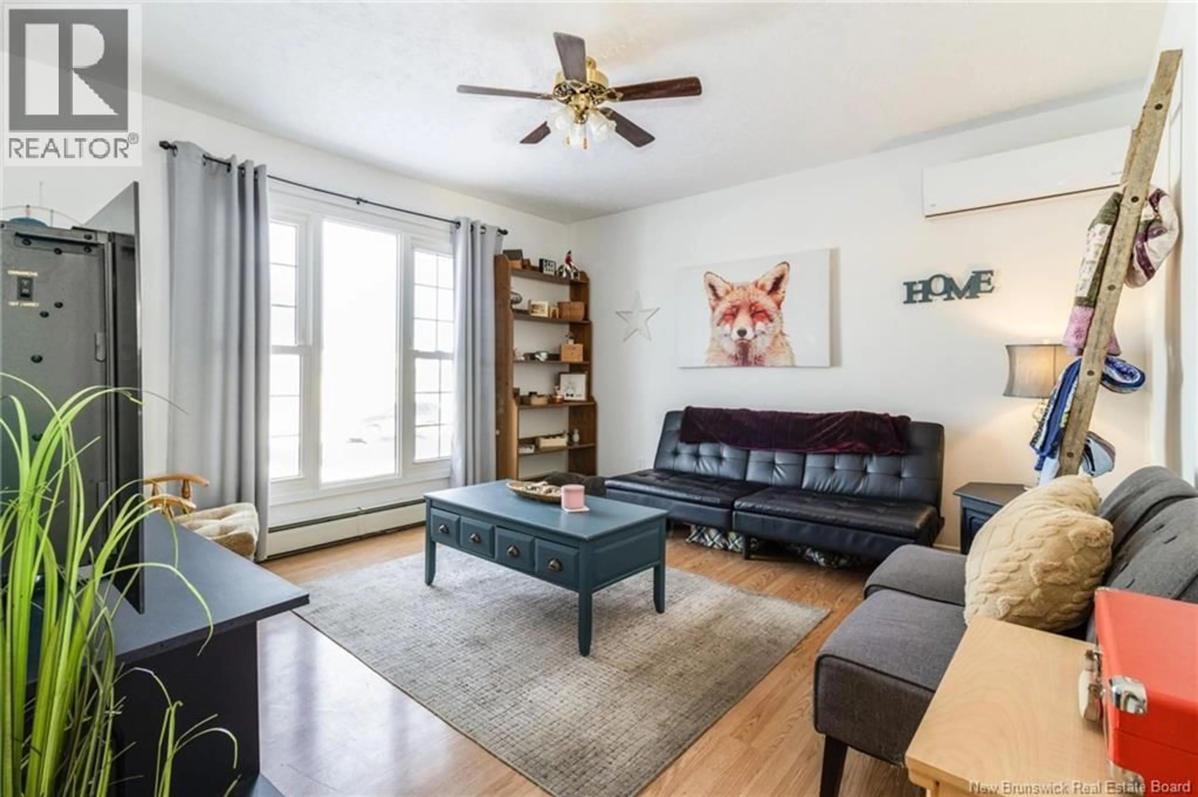 Living room with furniture, wood/laminate floor for 29 NASON CRESCENT, Oromocto New Brunswick E2V1K2