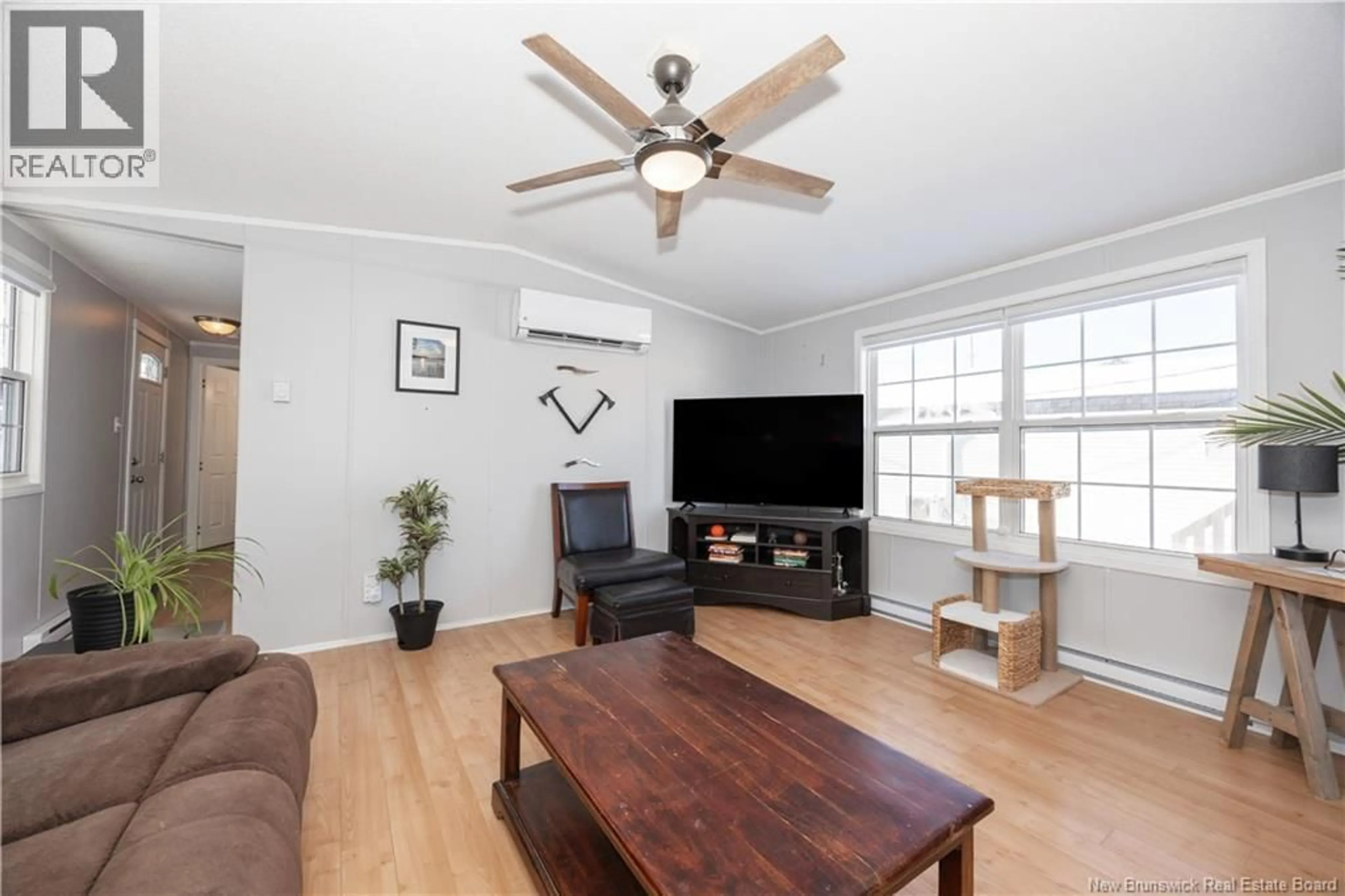 Living room with furniture, wood/laminate floor for 111 CURRIE CRESCENT, Waasis New Brunswick E3B7H3
