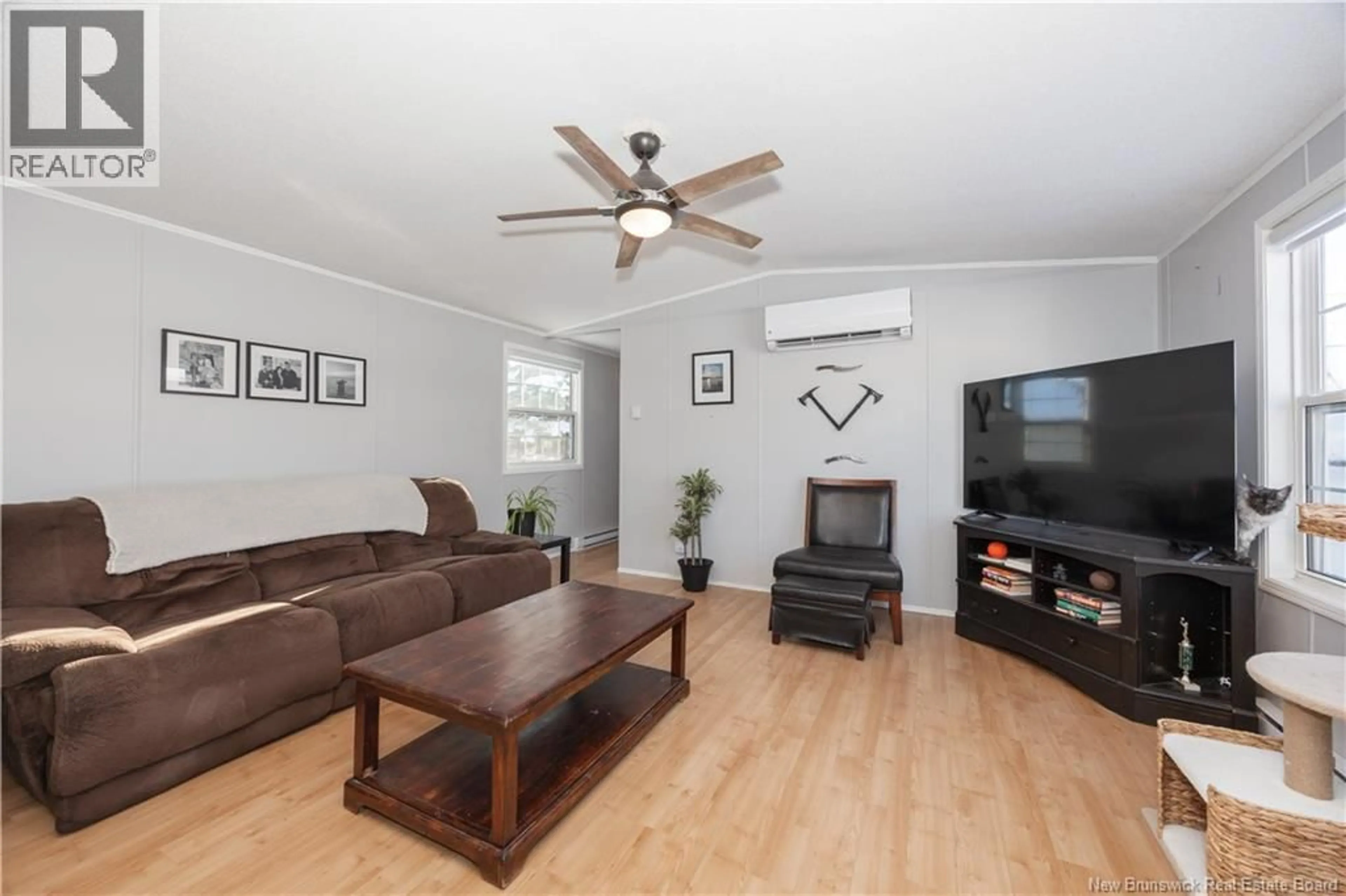 Living room with furniture, wood/laminate floor for 111 CURRIE CRESCENT, Waasis New Brunswick E3B7H3